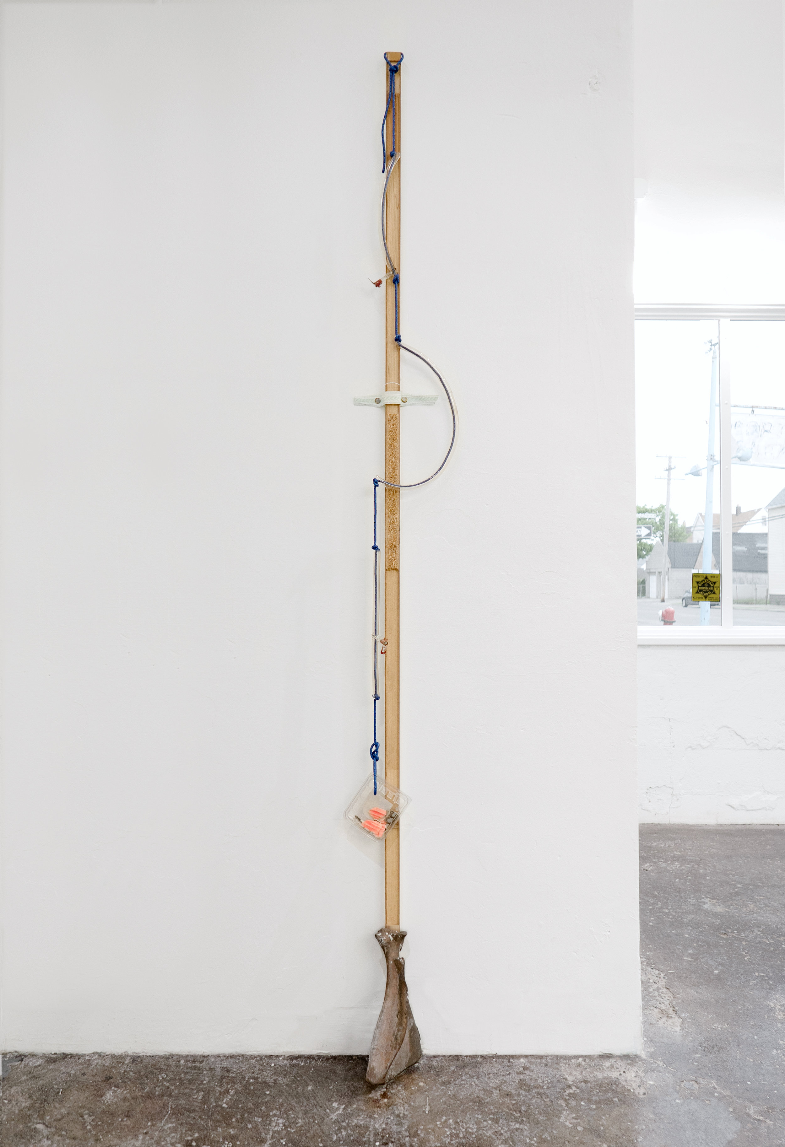  Matt Siegel,  N , 2019, Raw bronze, hollow core door, accessory cord, neon glass tubing (sourced: abandoned China Buffet, Evanston, WY), blueberry container, found objects, wind, 92 x 8 x 5 in 