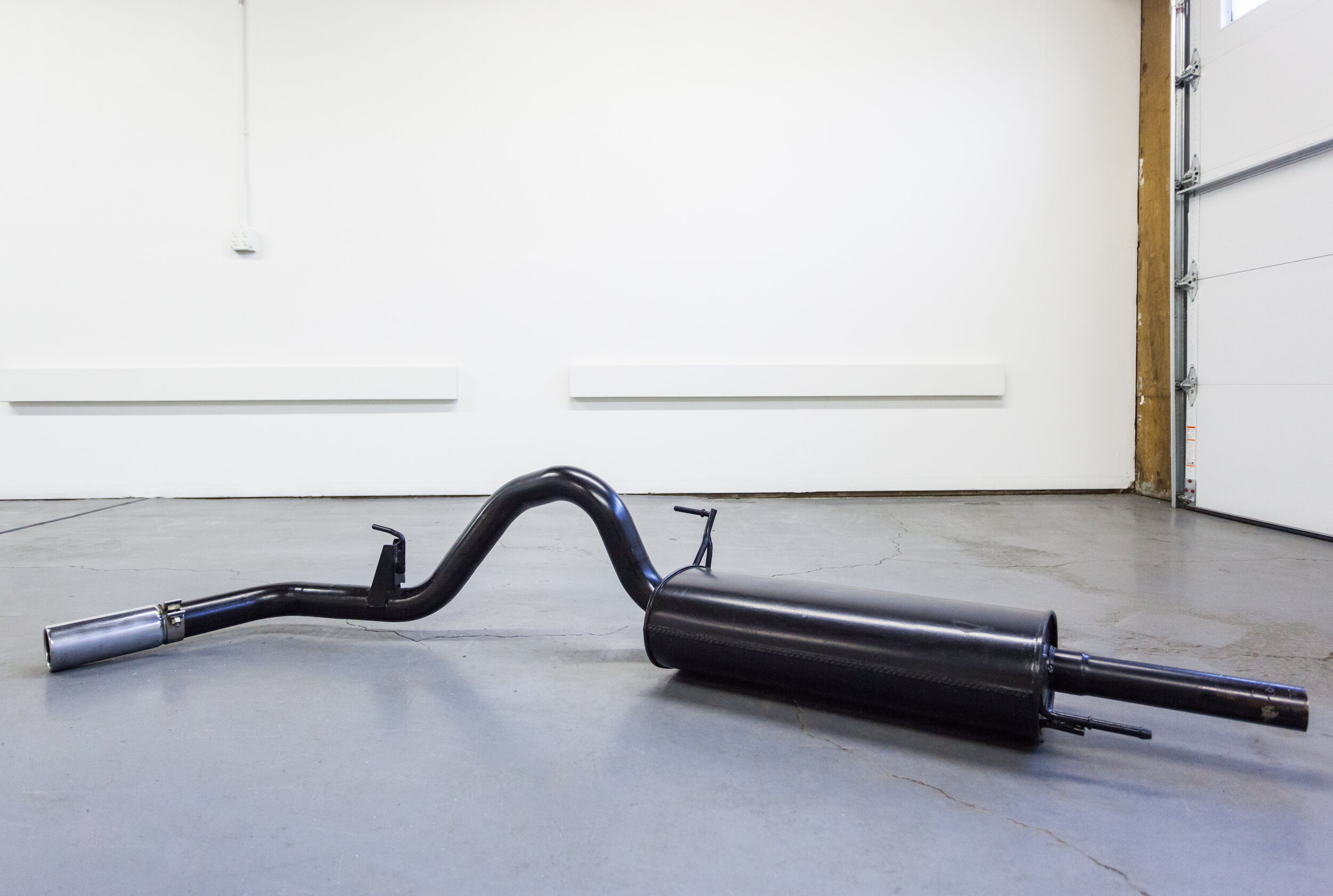   Situation, confrontation, scattered syntax, and ennui ​, 2019, Ford f150 exhaust system painted black by original owner, 86” x 16” x 12” 
