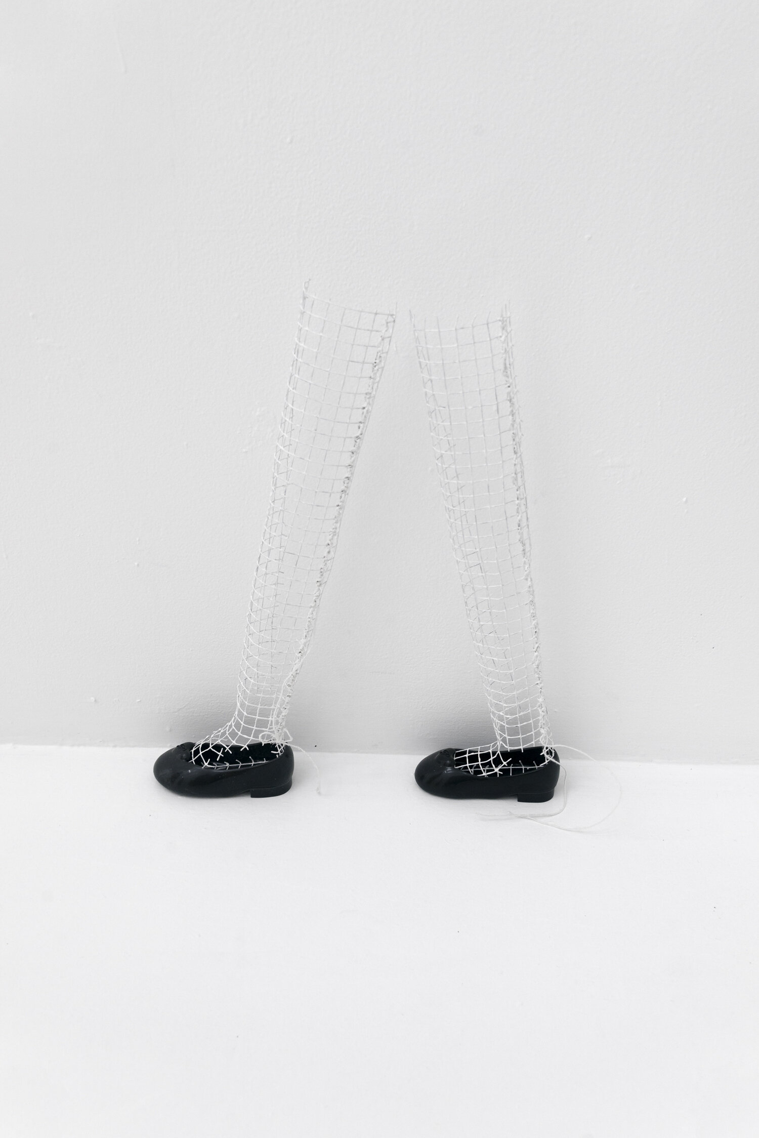   Tall Polio Legs , 2019, Doll shoes, steel, nylon thread, acrylic paint 20 x 16 x 3 in  