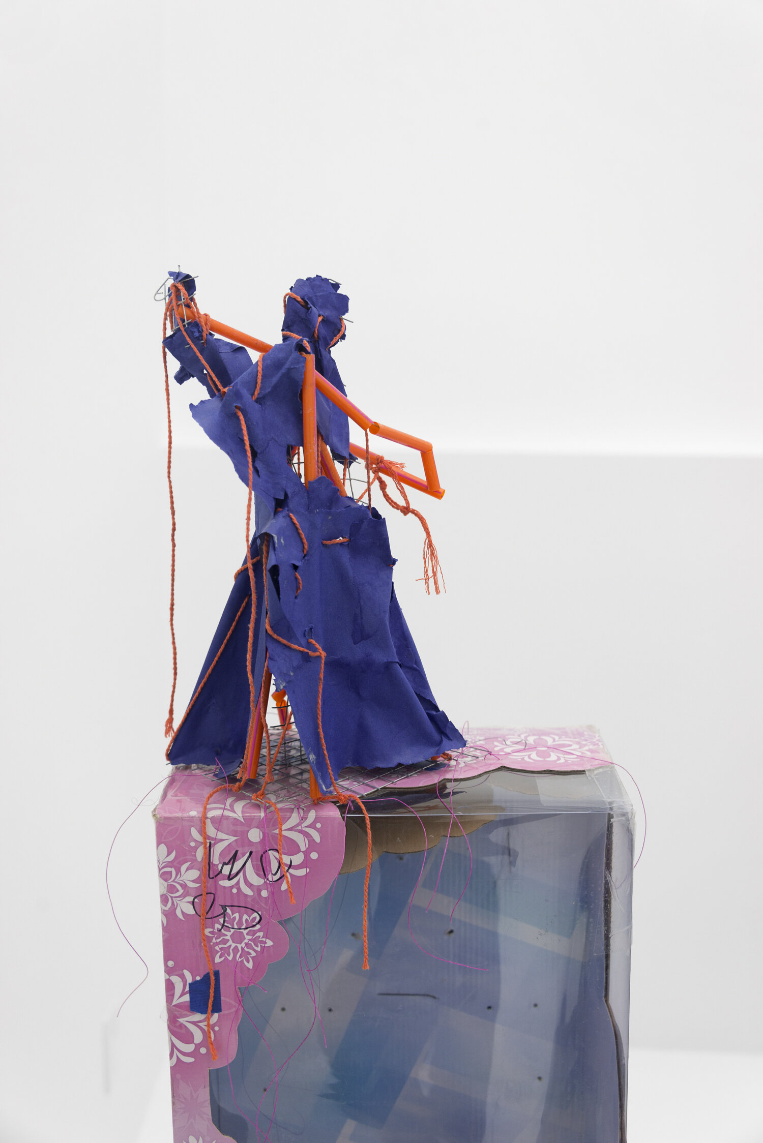   Angel 1b , 2019, Steel, paper, plastic straws, cotton twine. Pedestal: cardboard, plastic, waxed cotton thread 60 x 7.5 x 12.5 in (figure only 12.5 x 7.5 x 8.5 in)  