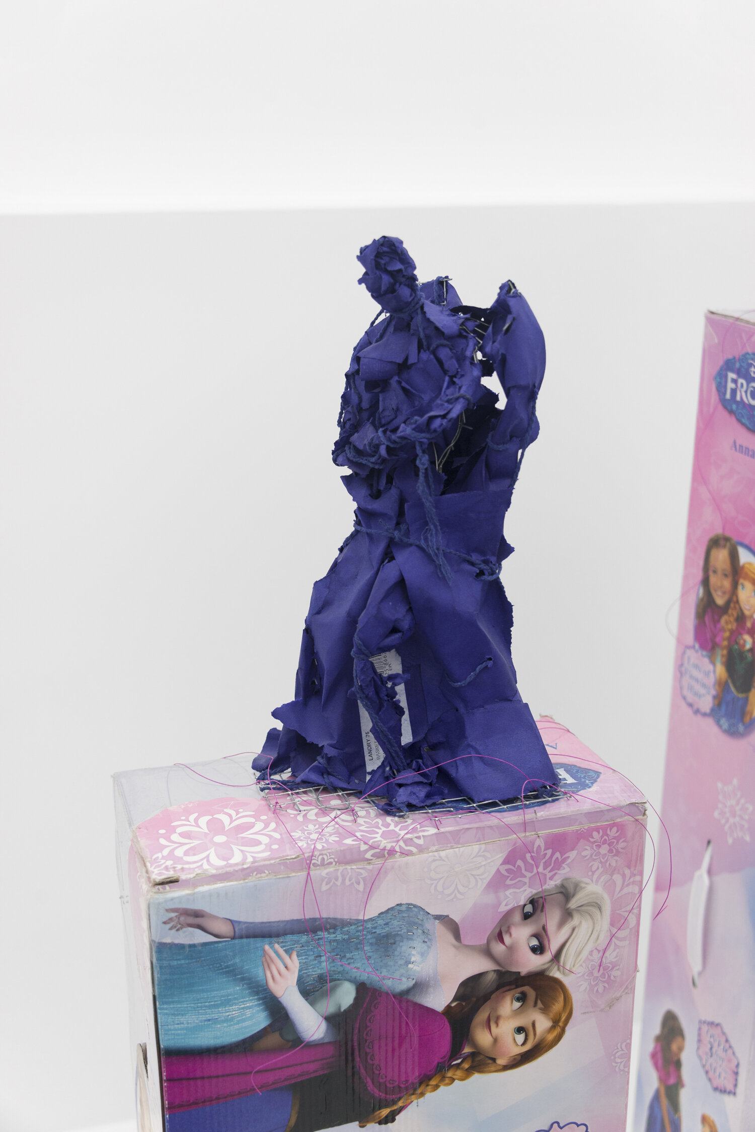   Angel 1a , 2019, Steel, paper, cotton twine. Pedestal: cardboard, plastic, waxed cotton thread 51 x 11 x 6 in (figure only 12.5 x 6 x 7 in)  