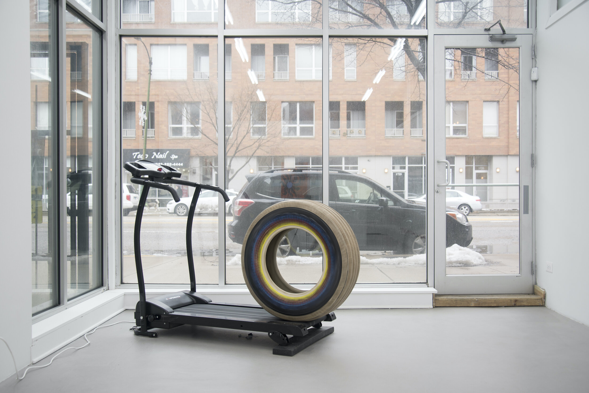  Gregory Bae,  24-7, 365 (#3) ​, 2015, treadmill set to 2.8 mph, acrylic and rubber on tire, wood  