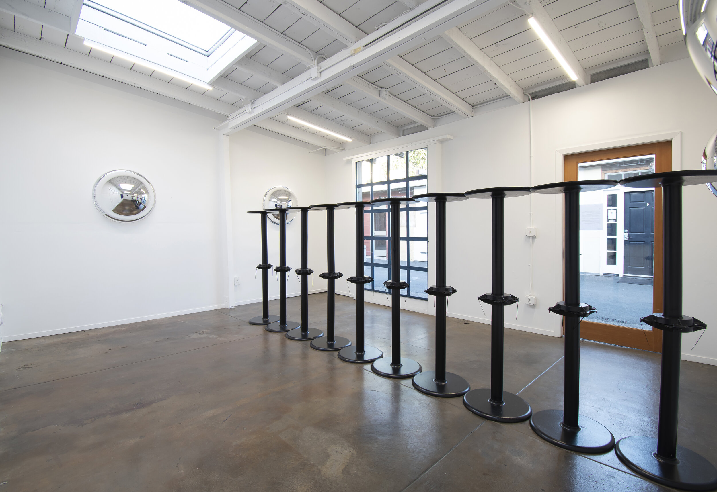  Débora Delmar,  Barrier (2) , 2020. 170 inches x 56 inches. 20 x   Lancaster Table &amp; Seating 17" Round Black 3" Standard Height Column Table Base, cable ties. 