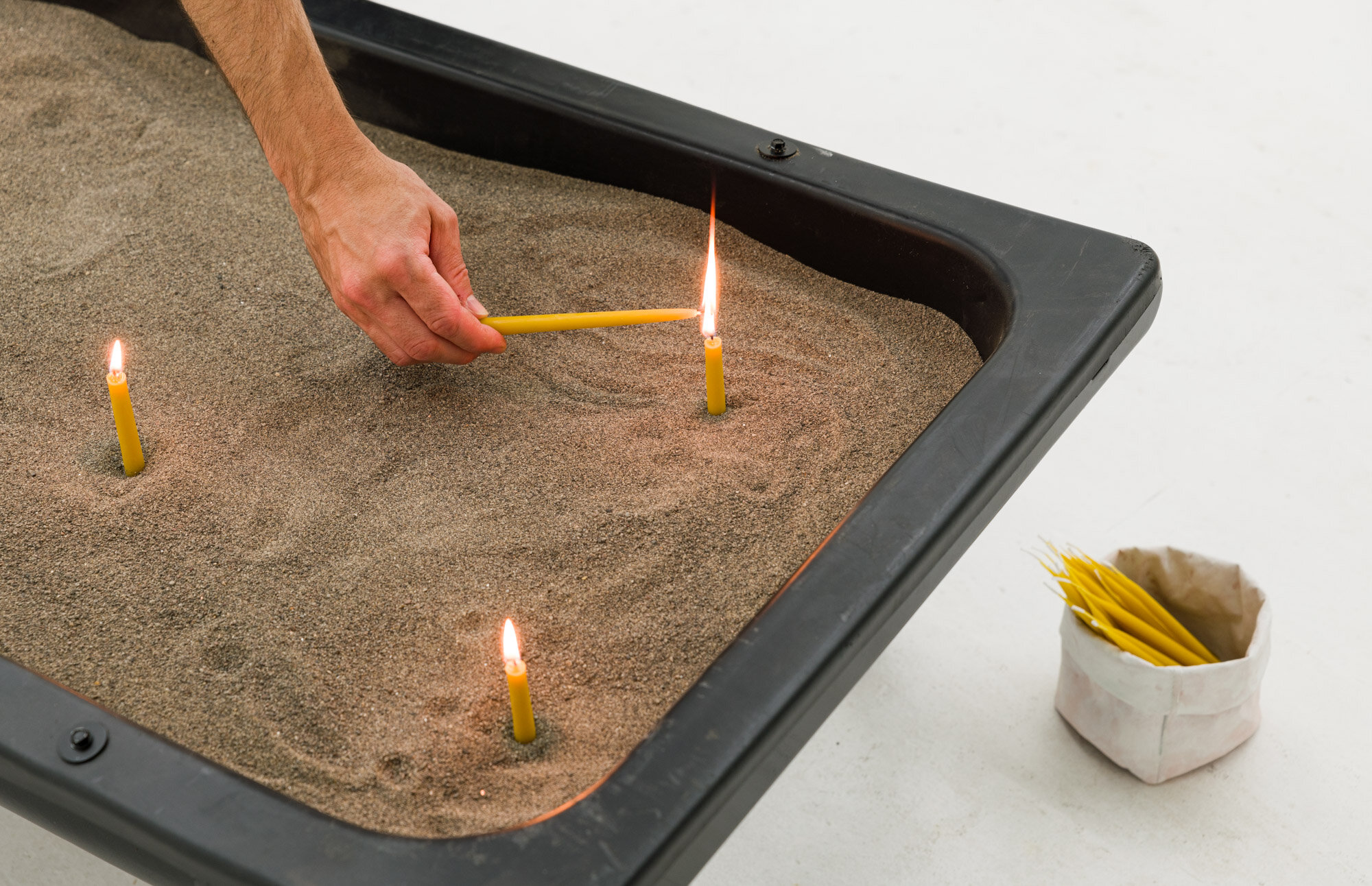  Kalaija Mallery,  Divination Trough ​, powder-coated livestock feeding trough, sand, hand-dipped beeswax candles, 5’ x 36” 