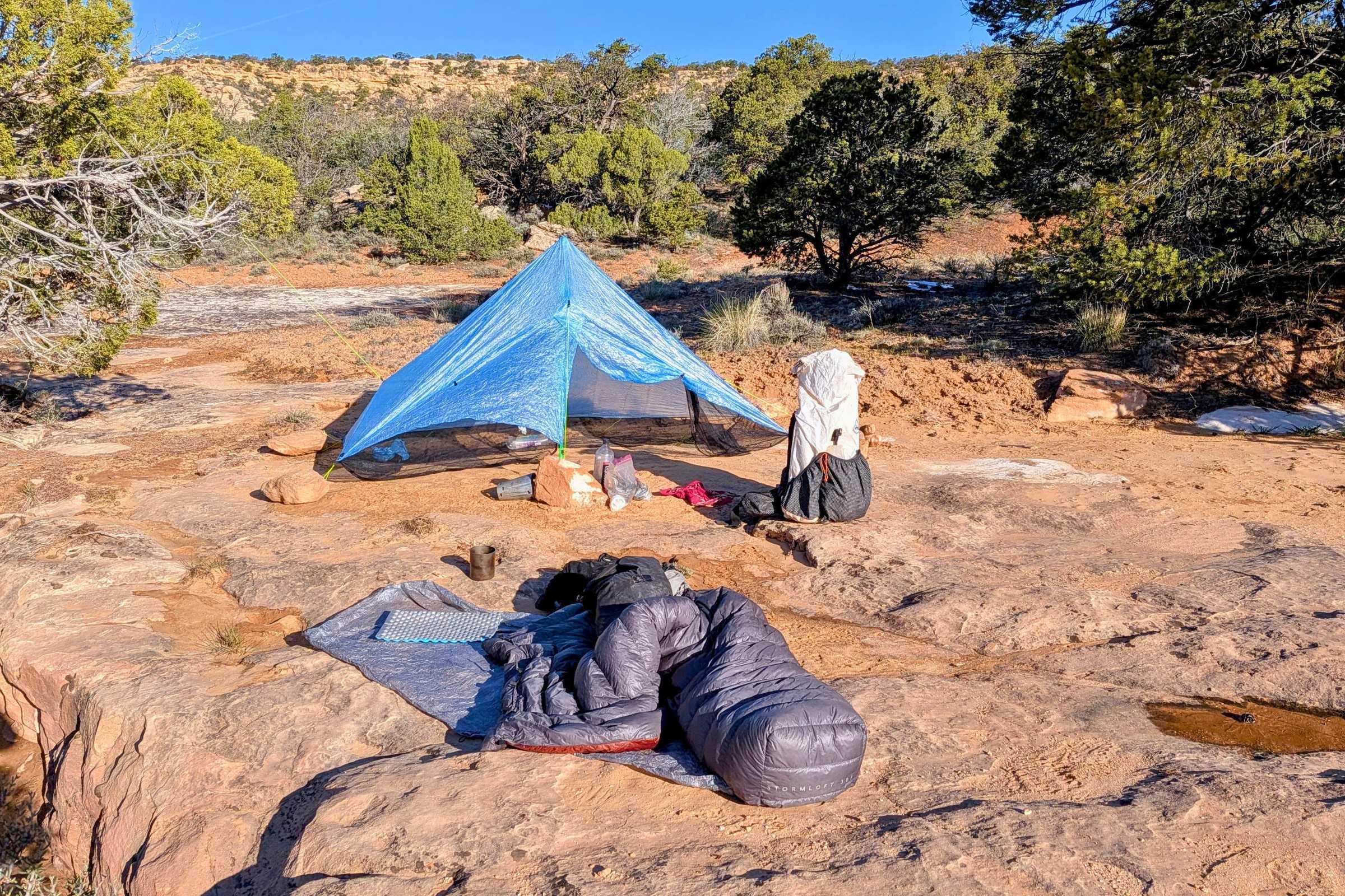 Zpacks Hexamid Ultralight Tent set up on the ground near a rock.