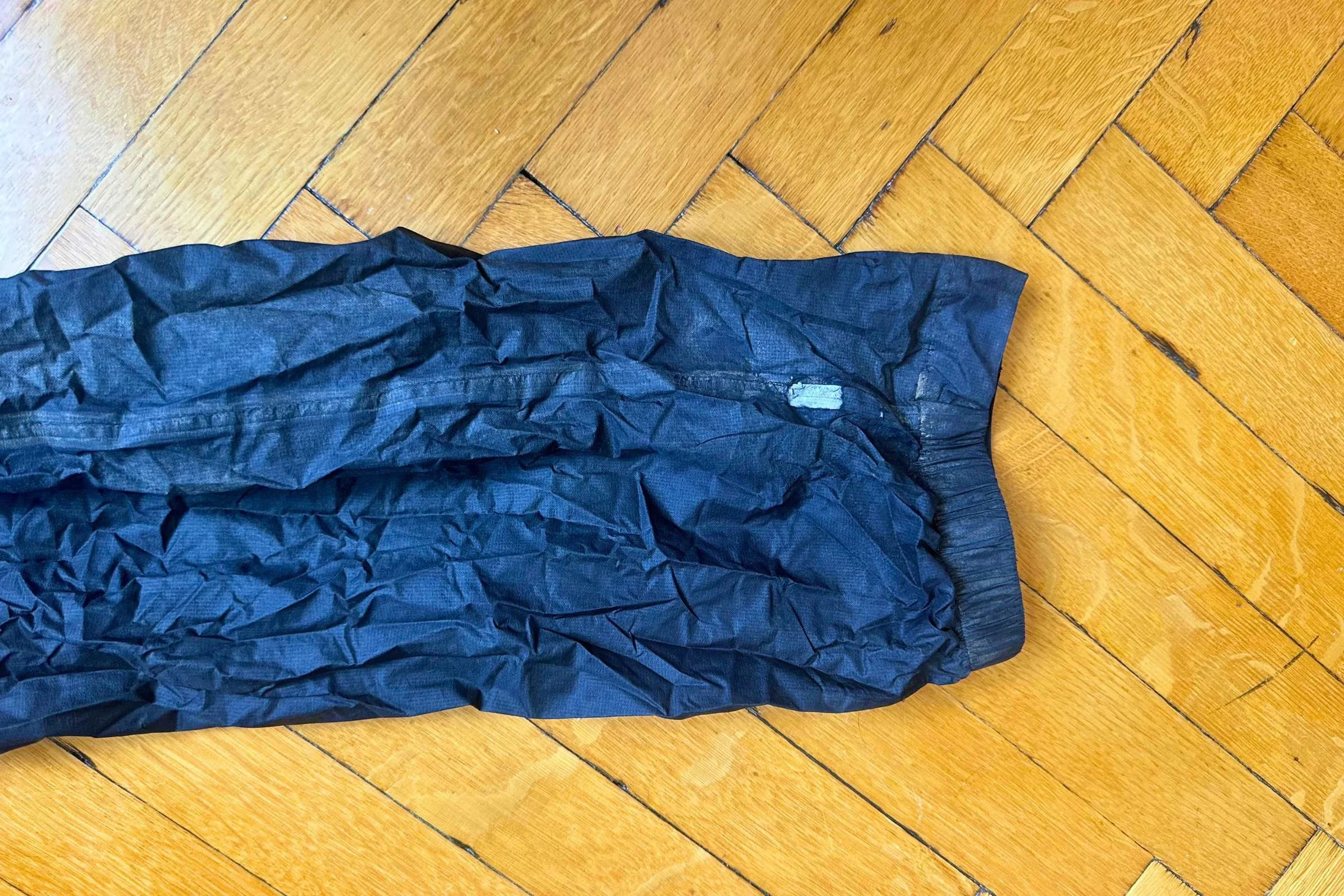 Worn away fabric on the left leg of the Outdoor research helium UL rain pants.