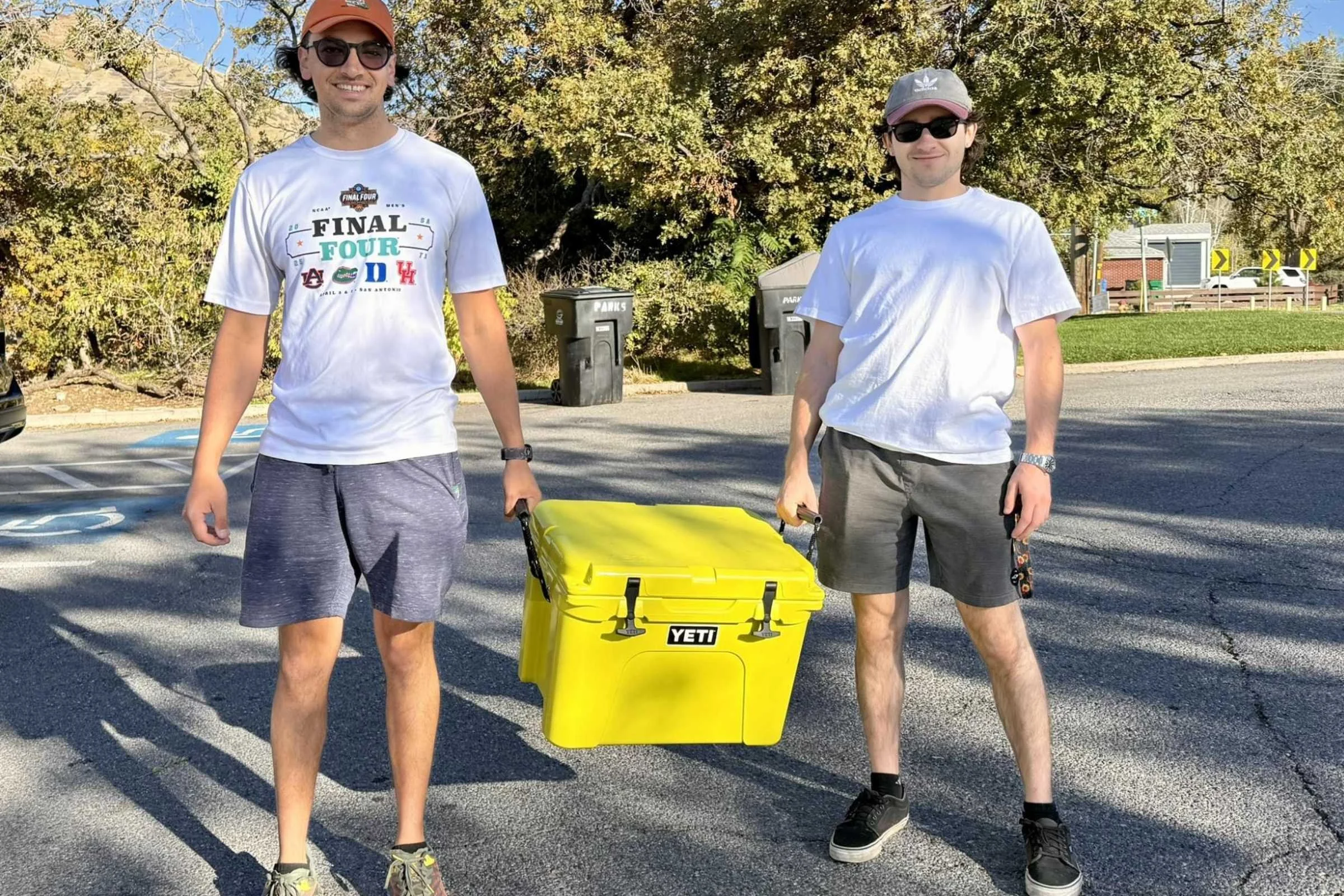 Two people carrying the YETI Tundra 35 using the rope handles.
