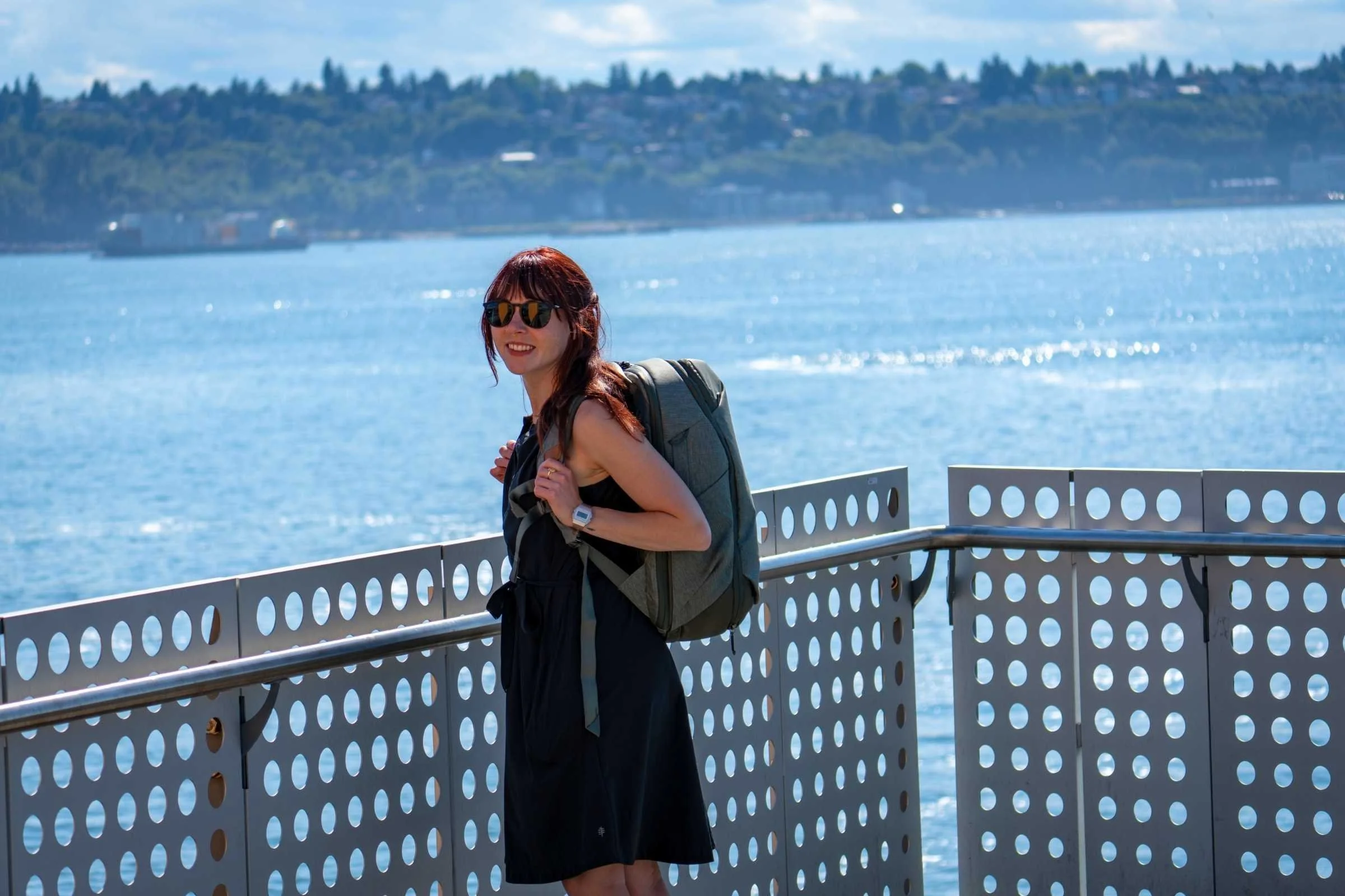 Women wearing the Royal Robbins Spotless hiking adventure dress standing on a pier while traveling
