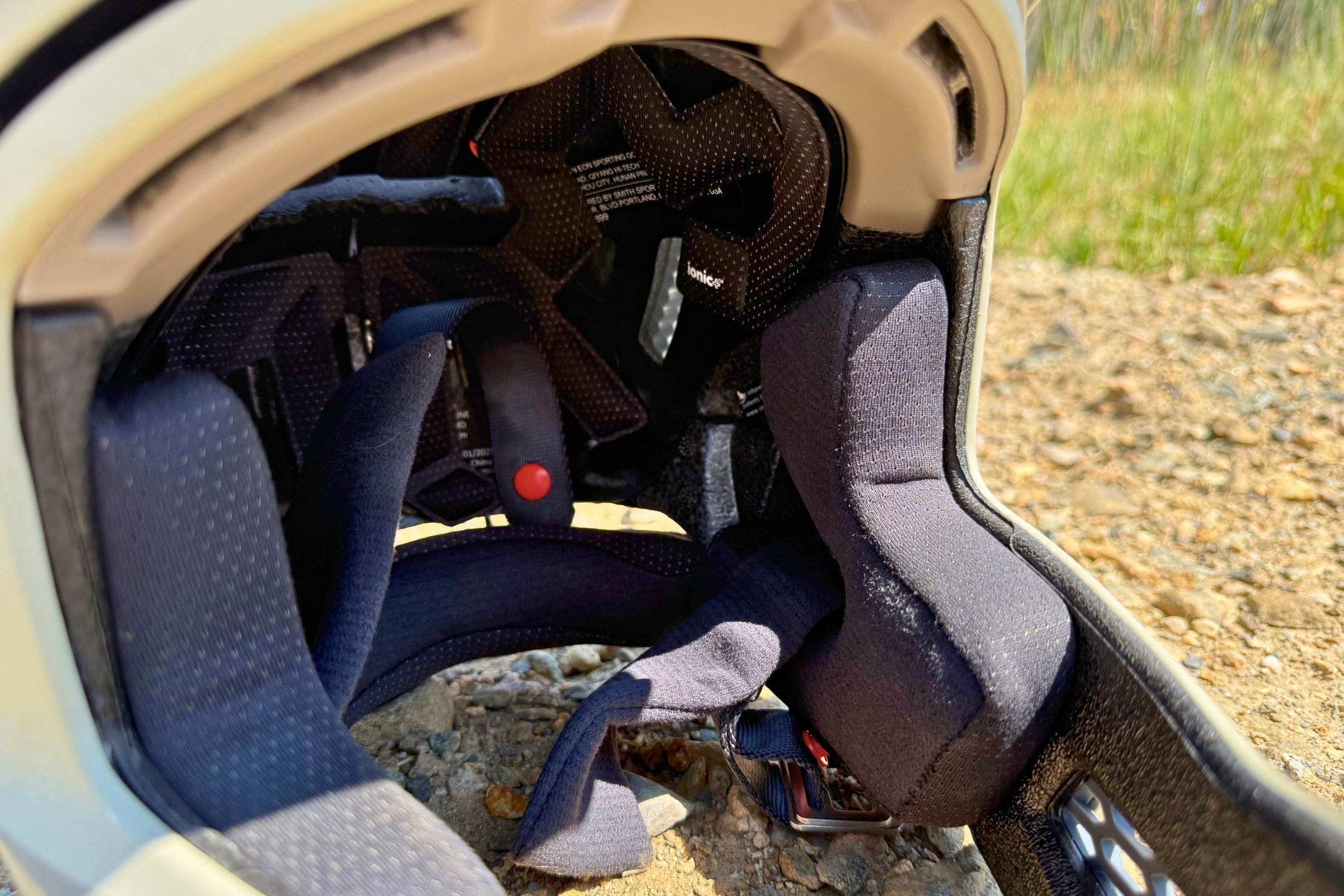 A close-up of a Smith Hardline helmet showing the ear pad and retention strap details.