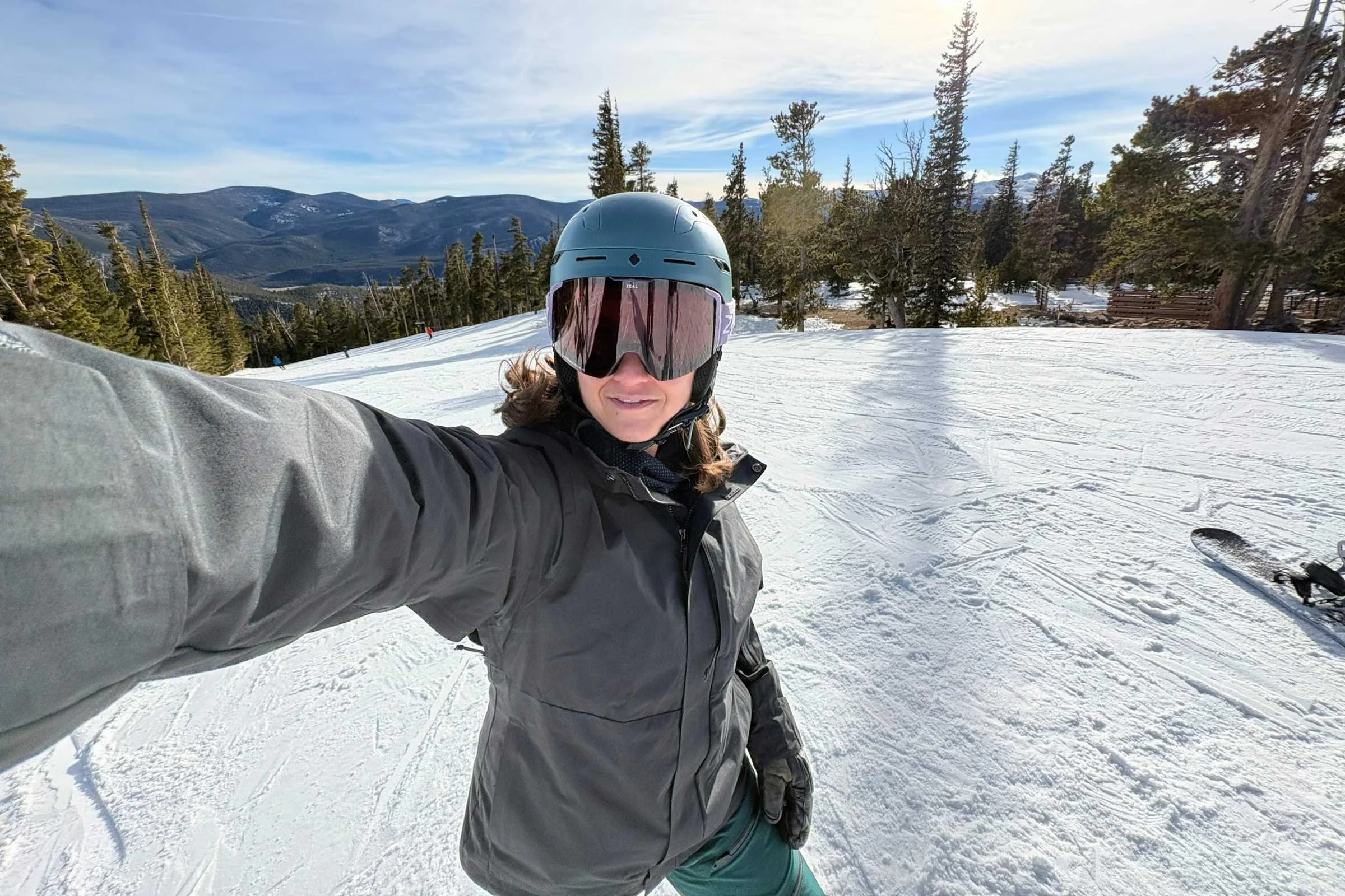 Snowboarder wearing REI Co-op Powderbound Insulated snowboard jacket riding on a snowy mountain slope