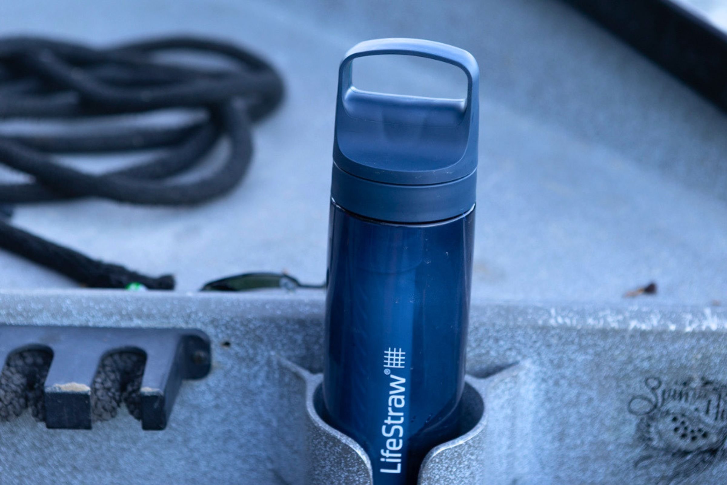 LifeStraw Go Series Travel Water Bottle in blue sitting in a boat cup holder.