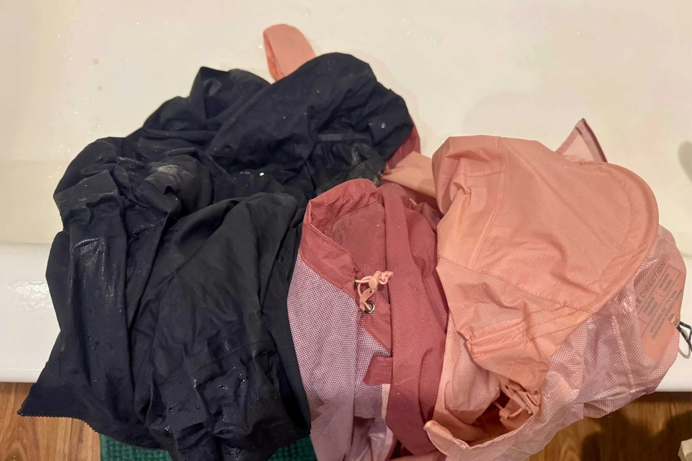 We shower-tested the Janji Rainrunner Pack Jacket (left) and Ultimate Direction Ultra Jacket (right) to directly compare waterproofness. Photo by Becca Downs