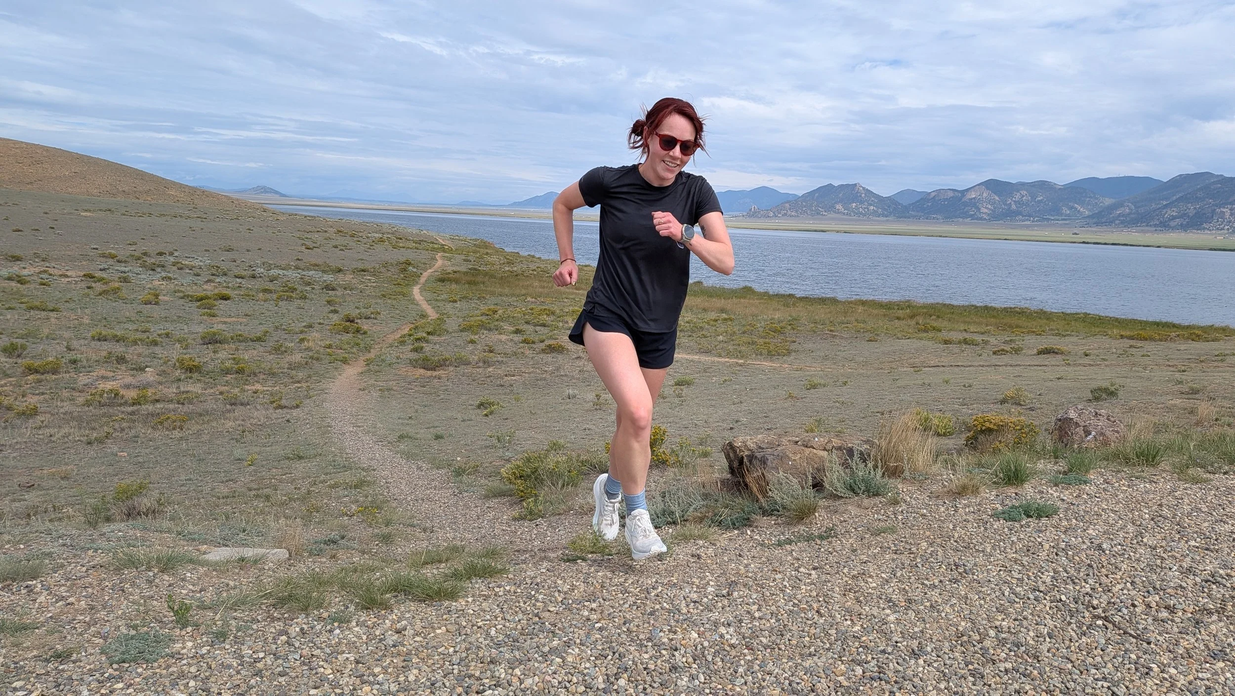 Woman running in Brooks Ghost trail running shoes.