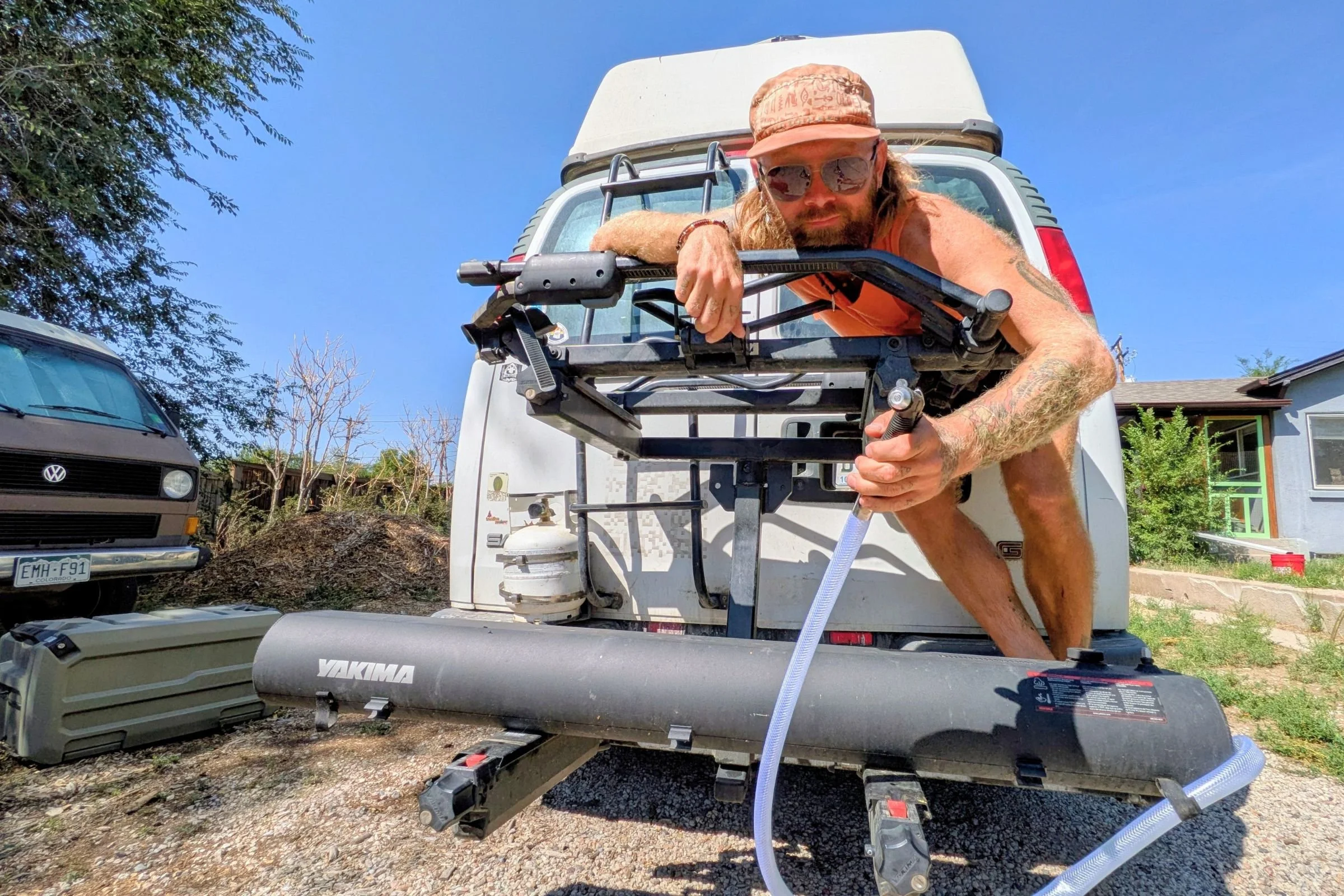 Man holding a Yakima RoadShower water pump.