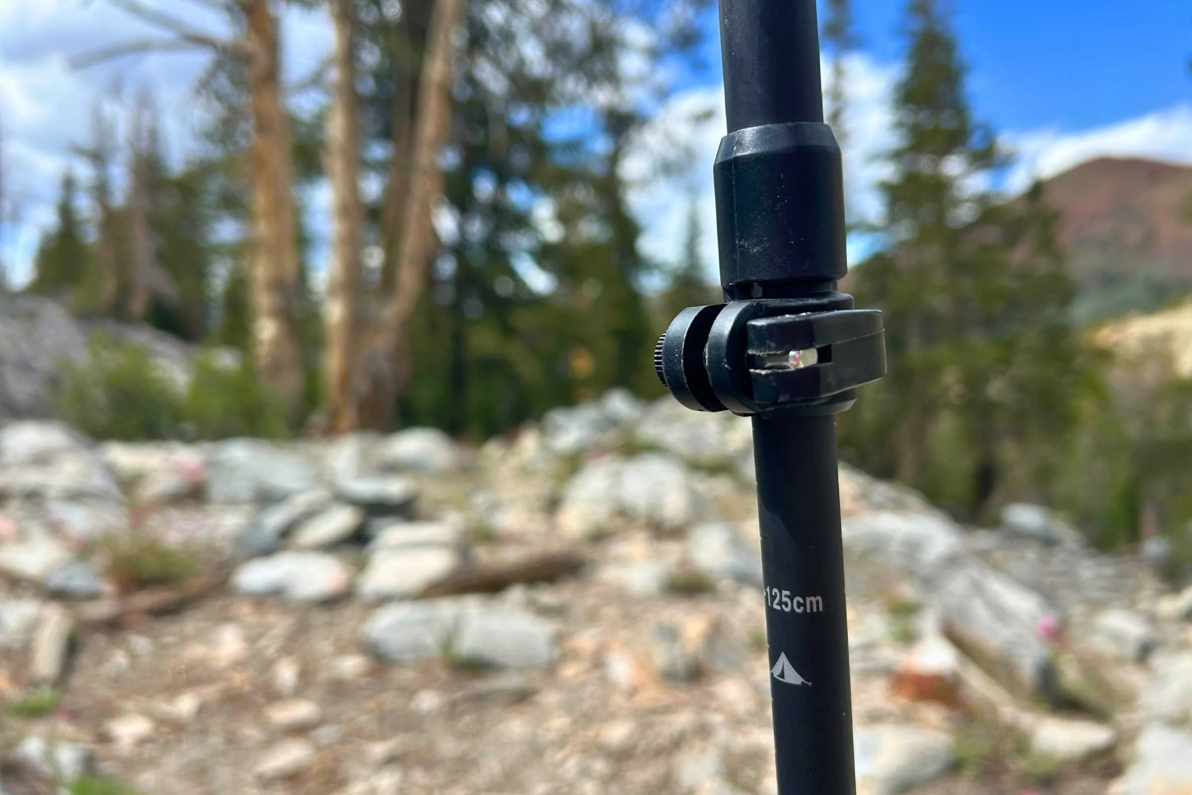 A closeup of the length marker on the Gossamer Gear FT3 trekking poles with rocks and trees in the background