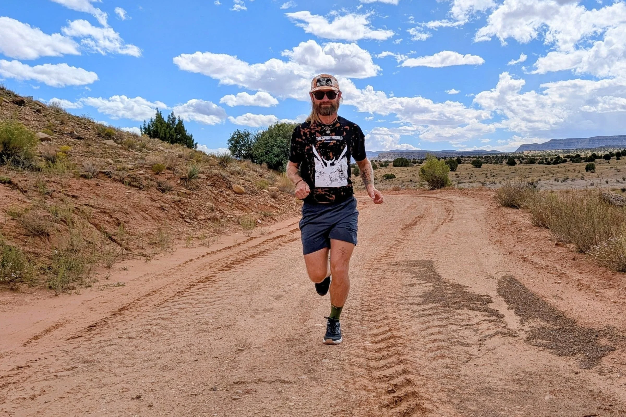 Author Sam Schild running on a hard-packed dirt road while wearing the Lems ZENSPEED+ shoes.