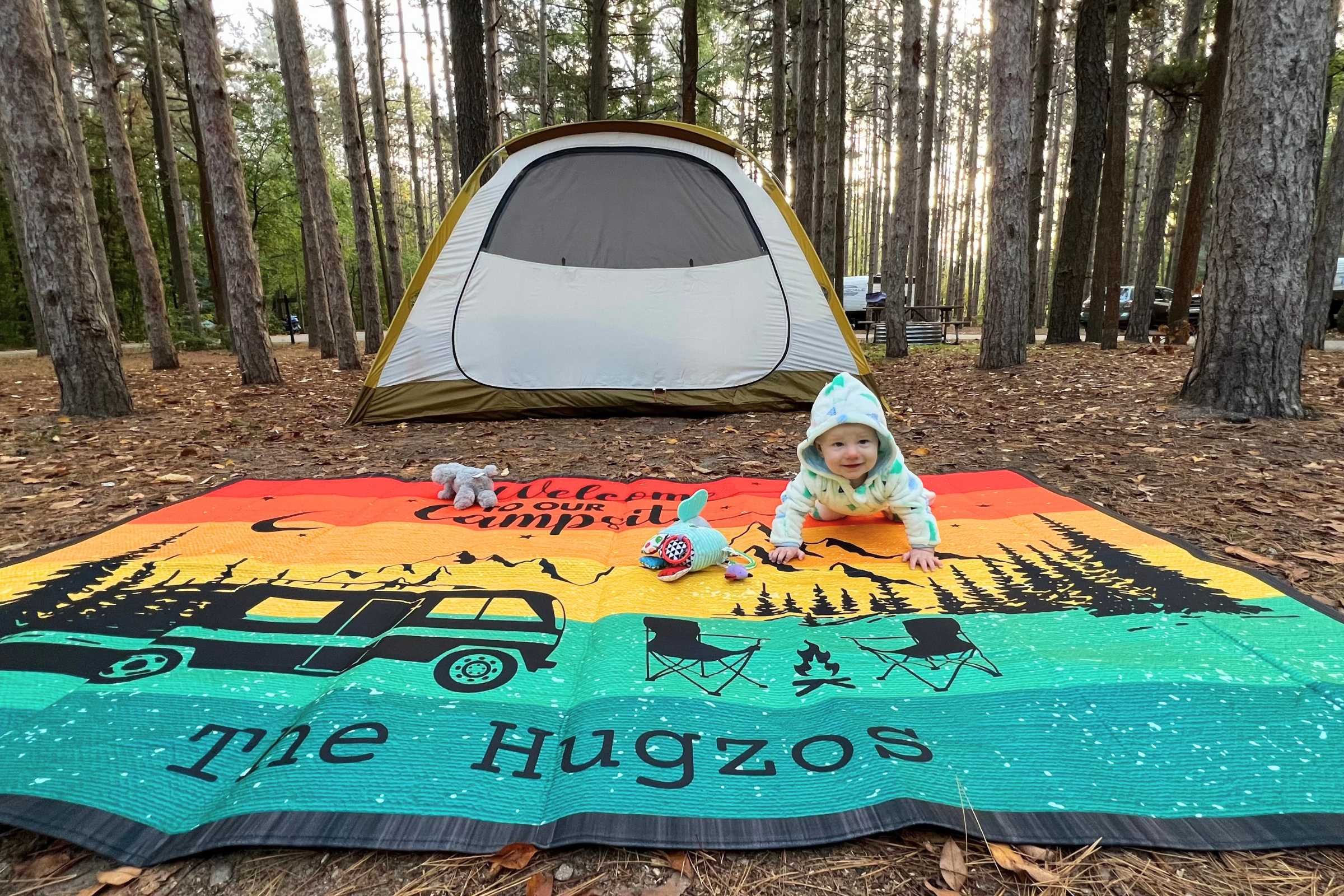 A baby crawls in front of the REI Base Camp 4 family car camping tent. Photo courtesy Erica Zazo