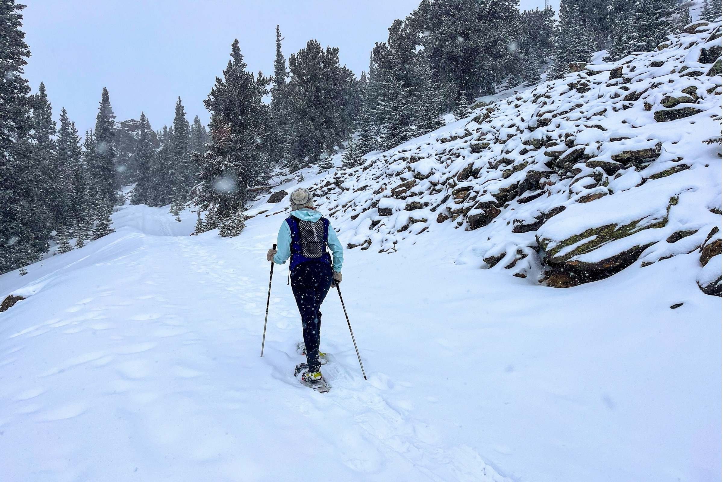 Treeline Review editor Becca Downs using poles to snowshoe on the Continental Divide
