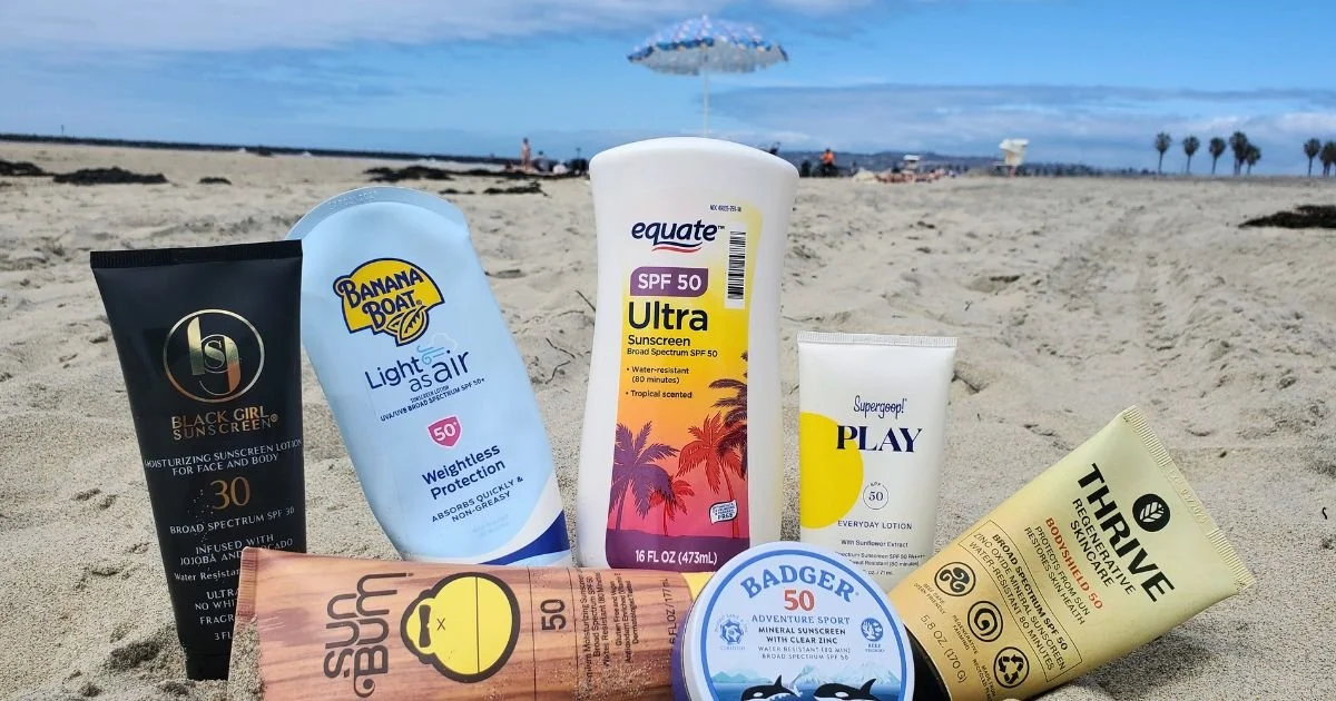 Body sunscreens displayed on a beach