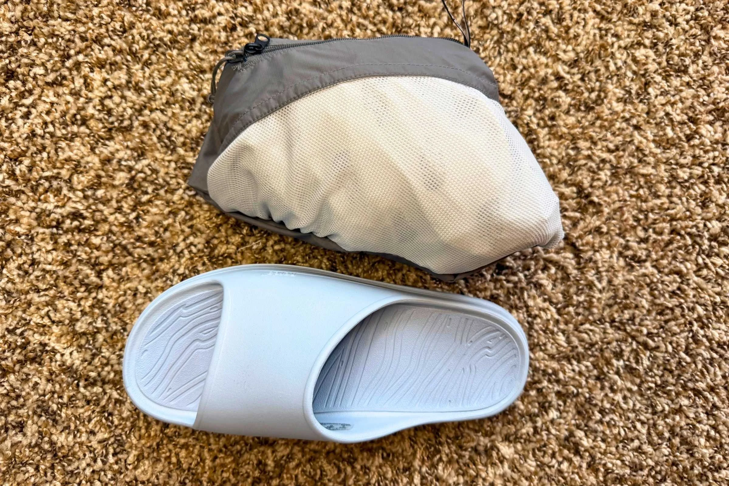 The North Face Alta Vista Ran Jacket packs down into its chest pocket.