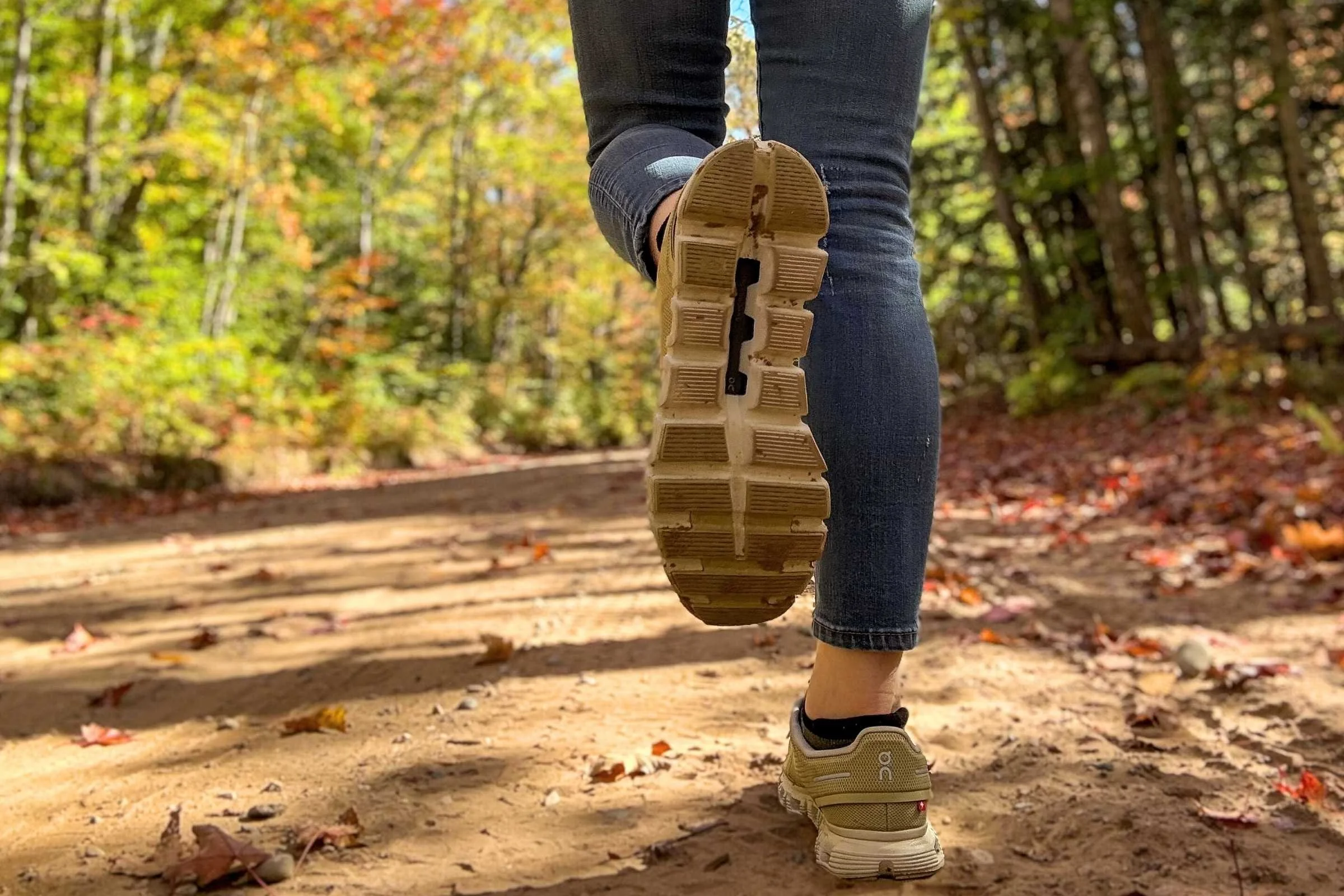 close-up of on cloud 6 outsole while walking on a dirt road