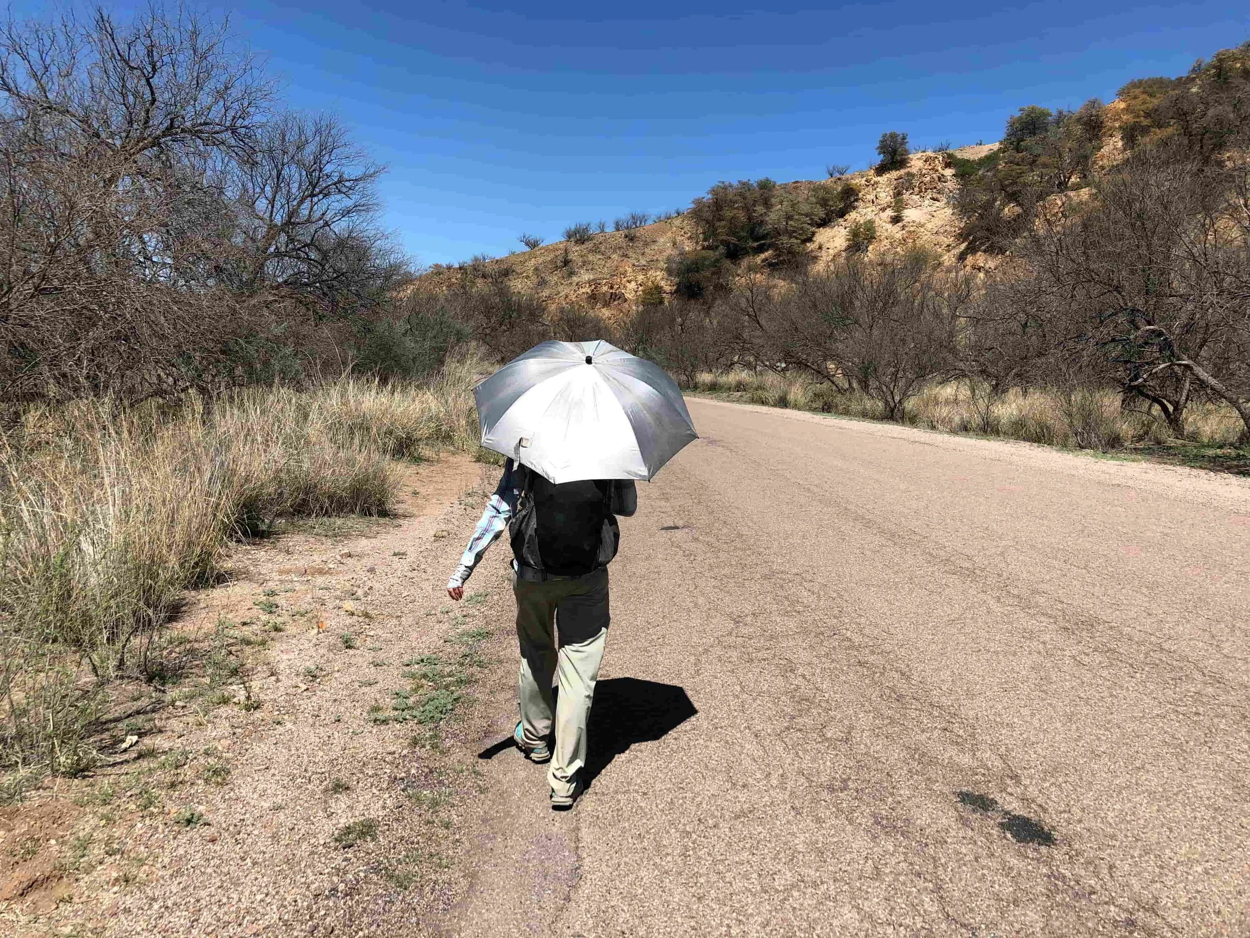 Naomi using a sun umbrella on a road walk on the Arizona Trail. Photo courtesy Mke Unger