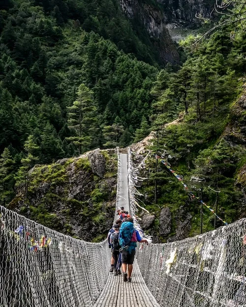 People crossing a footbridge.