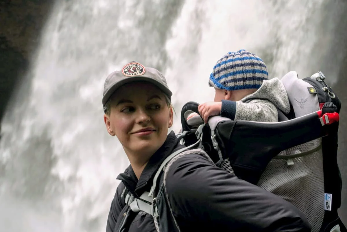 The writer, Ebony Roberts, hiking near a waterfall with the Osprey Poco. Photo by Steve Redmond.
