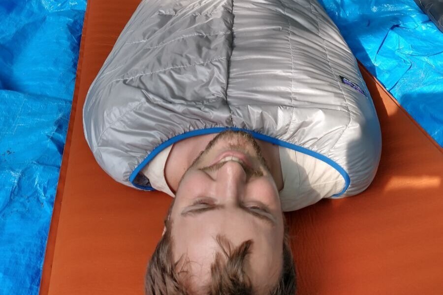What are the benefits of rolling up your sleeping bag rather than