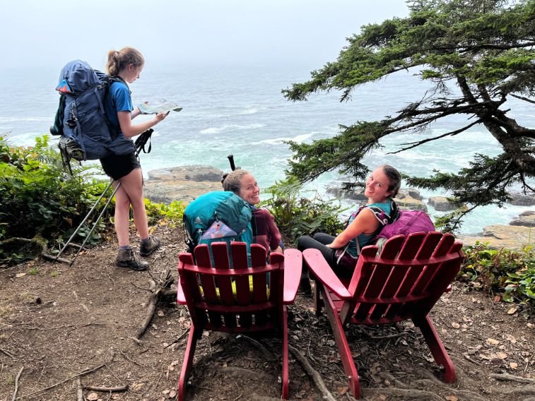 Day-6.4-WCT-red-Adirondack-chairs-and-trail-friends.jpg