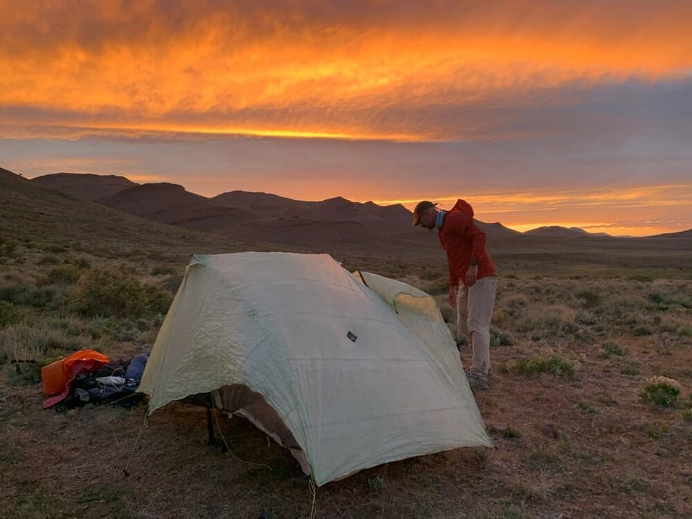 setting-up-tent-at-sunset-in-pueblo-mountains.jpg