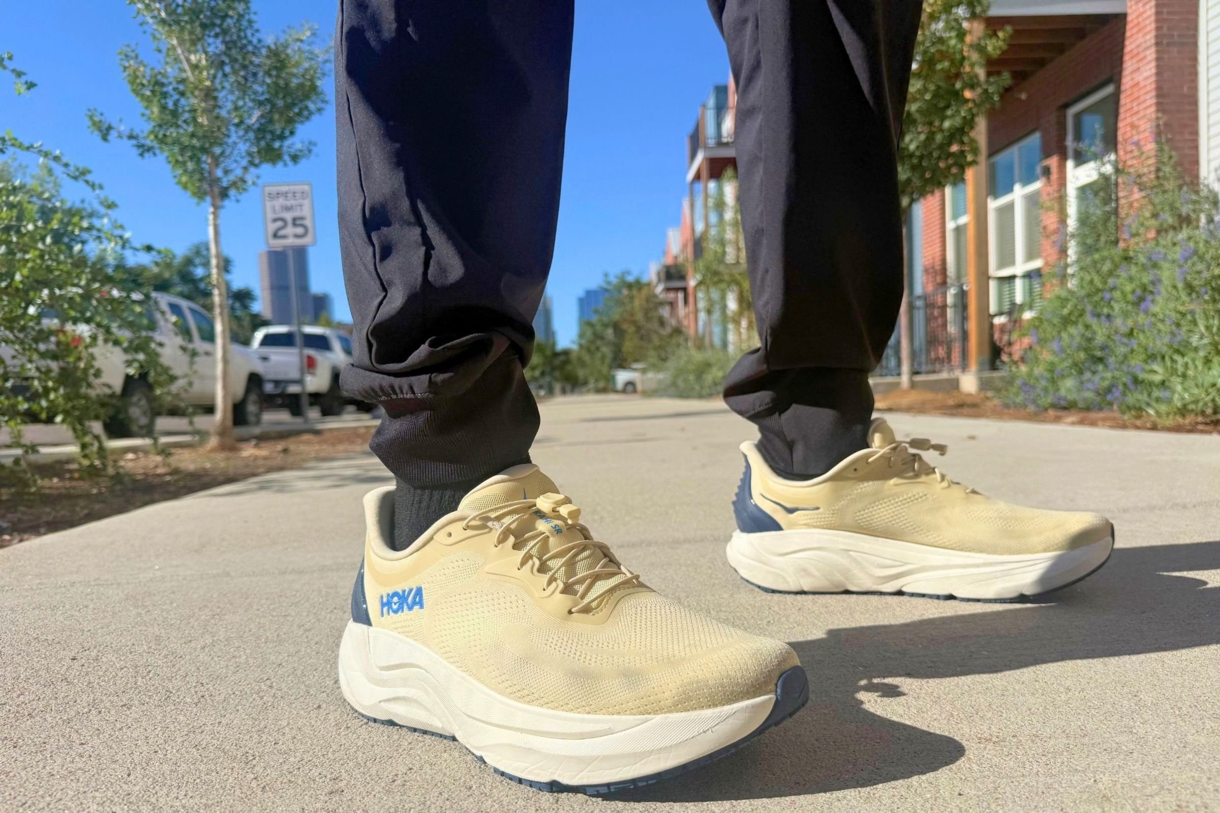 Man in HOKA Arahi SR shoes standing on pavement