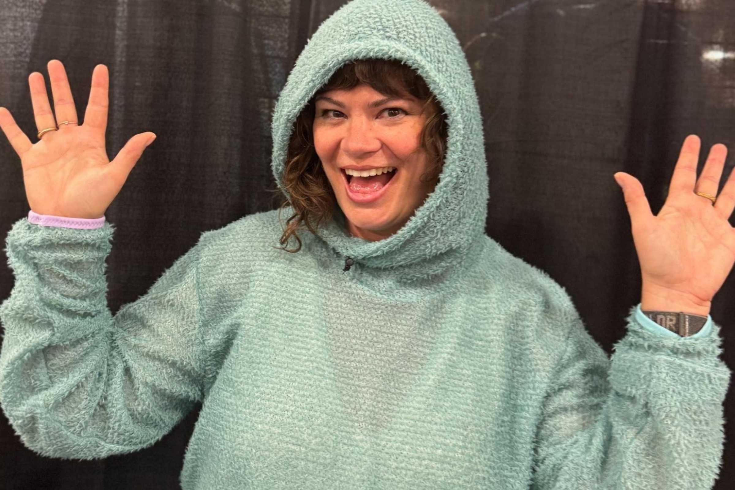 Shawnté models a cozy Alpha 60 Hoodie from Sambob, one of the many emerging brands on display.