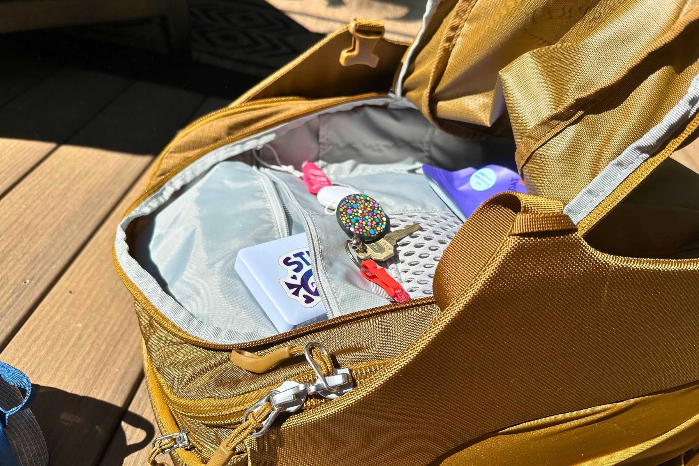 The front pocket has lots of organization. Here we were able to stash a key, phone charger, toiletry bag, chair and crochet project. Photo courtesy Sara Kruglinski.