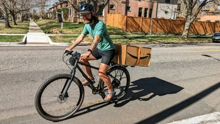 Using the Axiom Journey Rack to transport a large box that exceeds the rack's weight capacity.