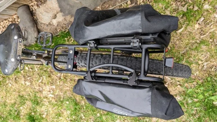 The top platform on the Axiom Streamliner is narrow, and the sides of the rack slope outward to reach the width of your bike’s rear dropouts.