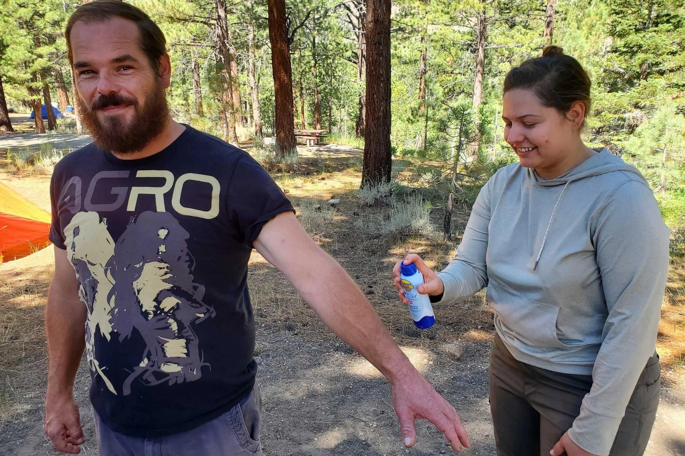   Spraying the Banana Boat Light as Air sun sunscreen on at a campsite in the Sierra.  