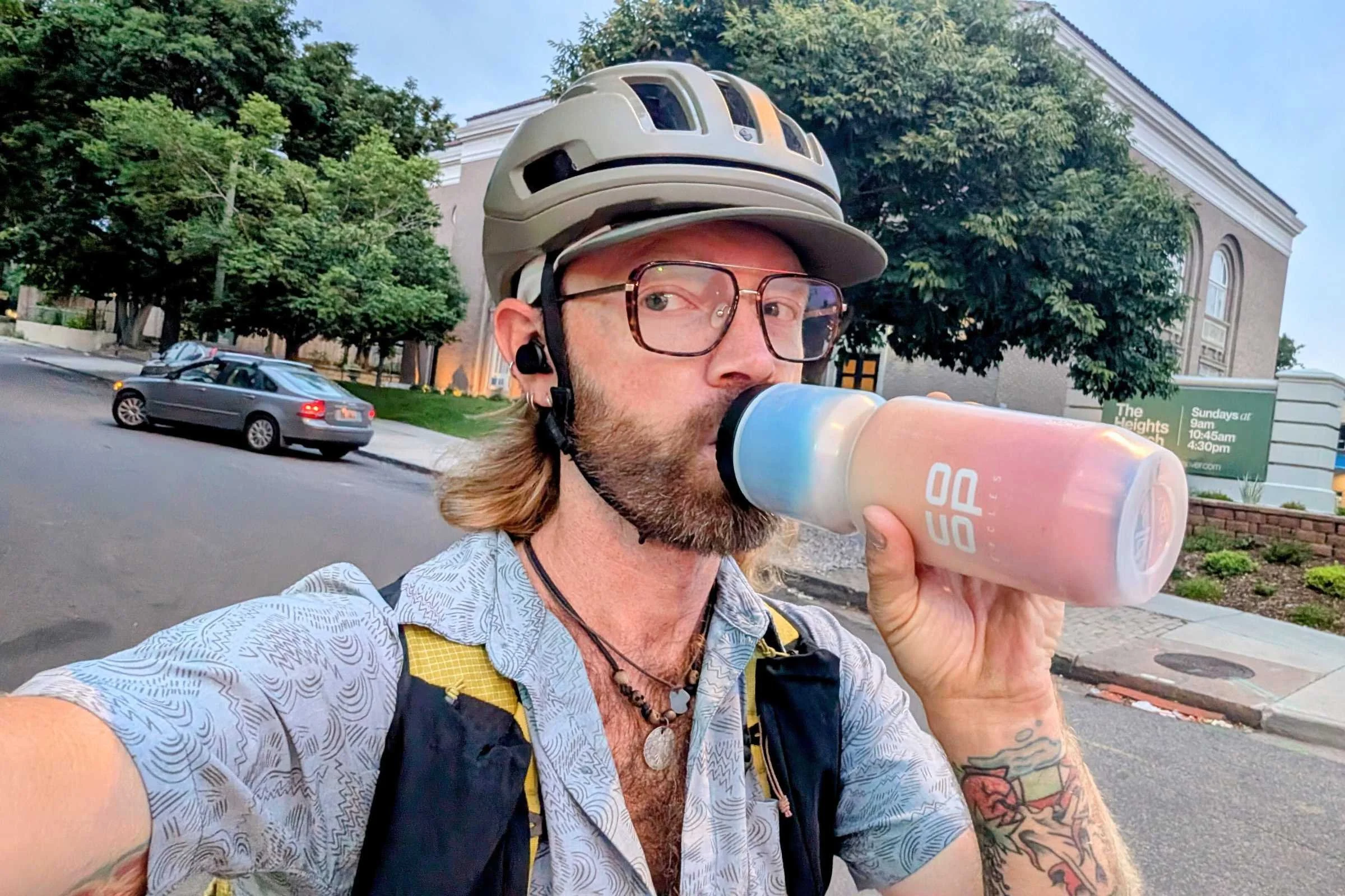 Biker drinking out of the REI Co-op Insulated Water Bottle 23 oz
