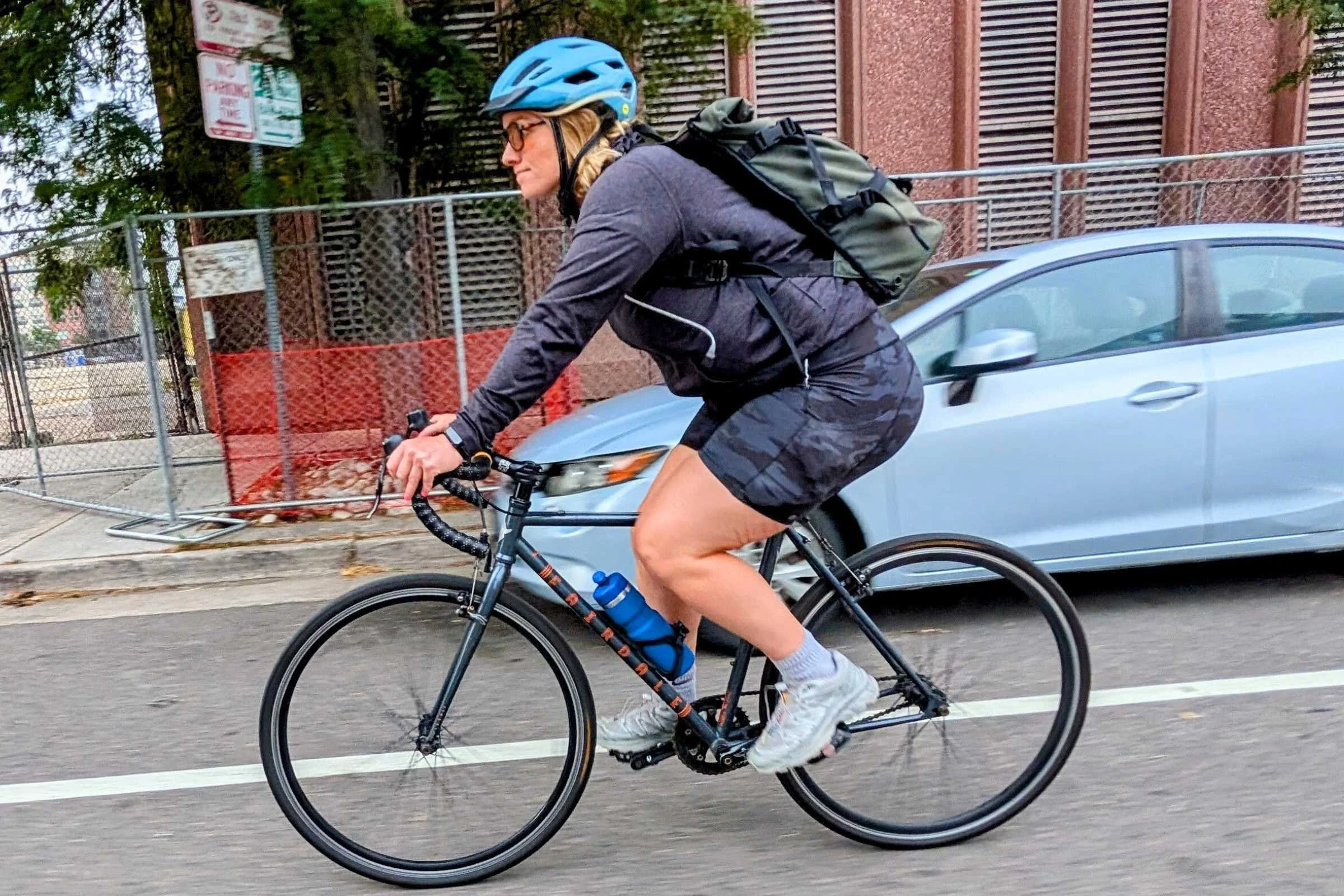 Biker riding down the street with the Bivo Trio Bottle 21 oz insulated in the water bottle holder