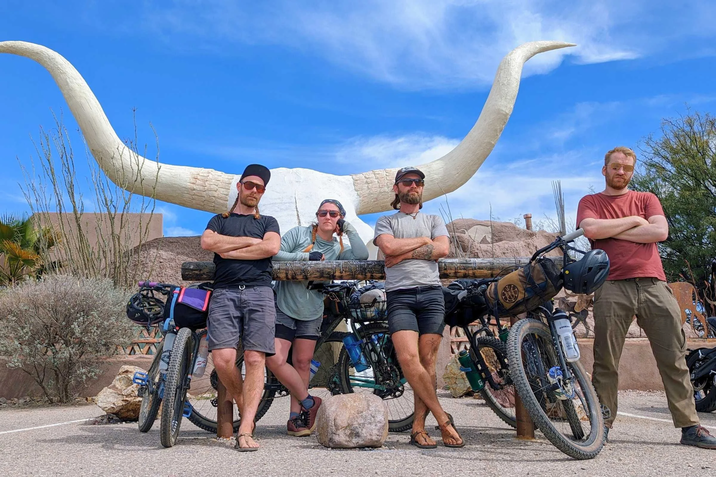 Group of bikers testing the Trek Voda posed in front of a giant skull with horns