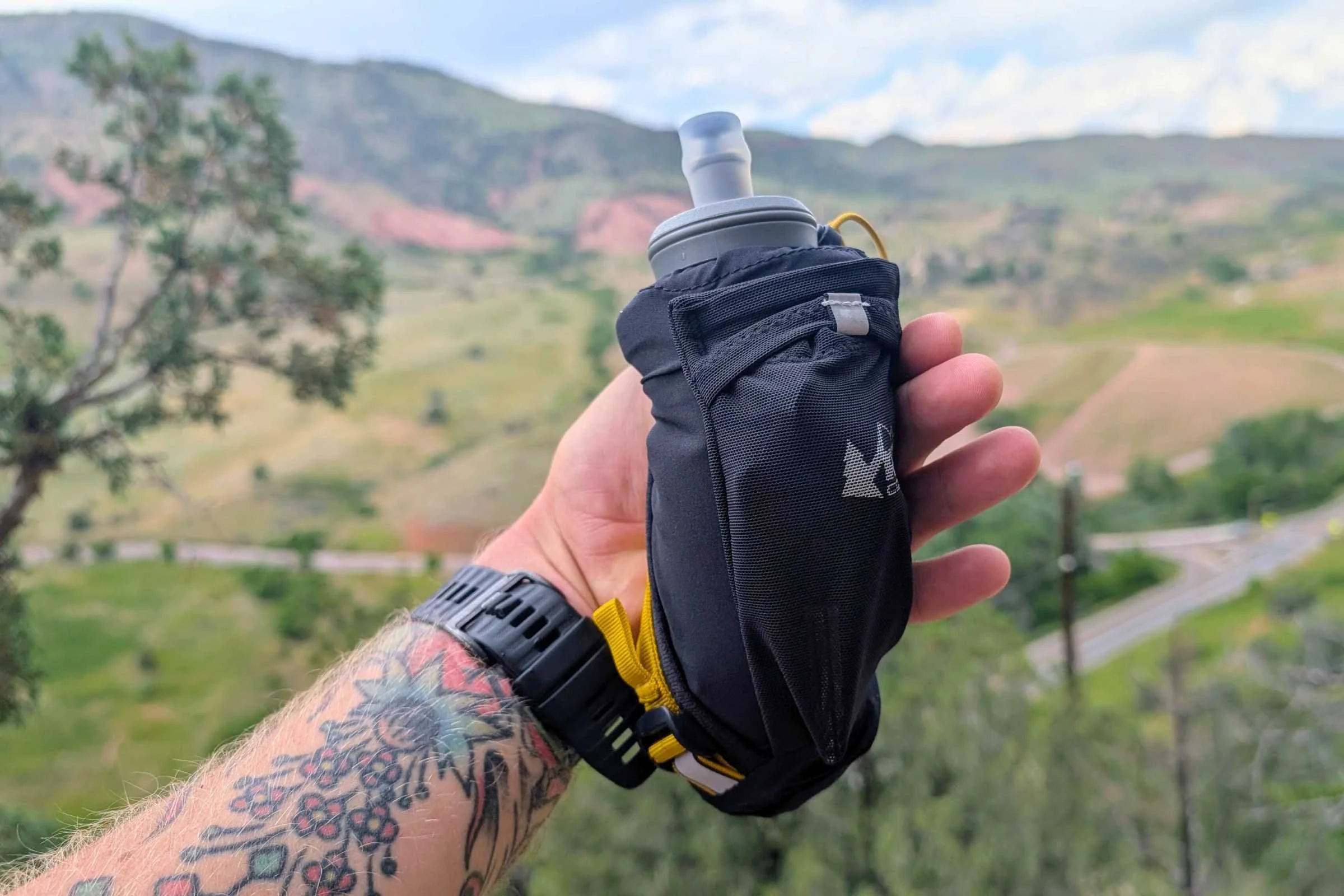REI Co-op Swiftland Handheld Water Bottle - 14 fl. Oz in a person’s hand