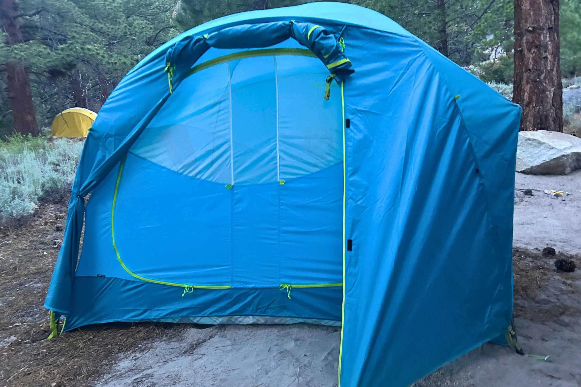 View of the NEMO Aurora Highrise Camping tent with half the vestibule rolled up looking at the closed door