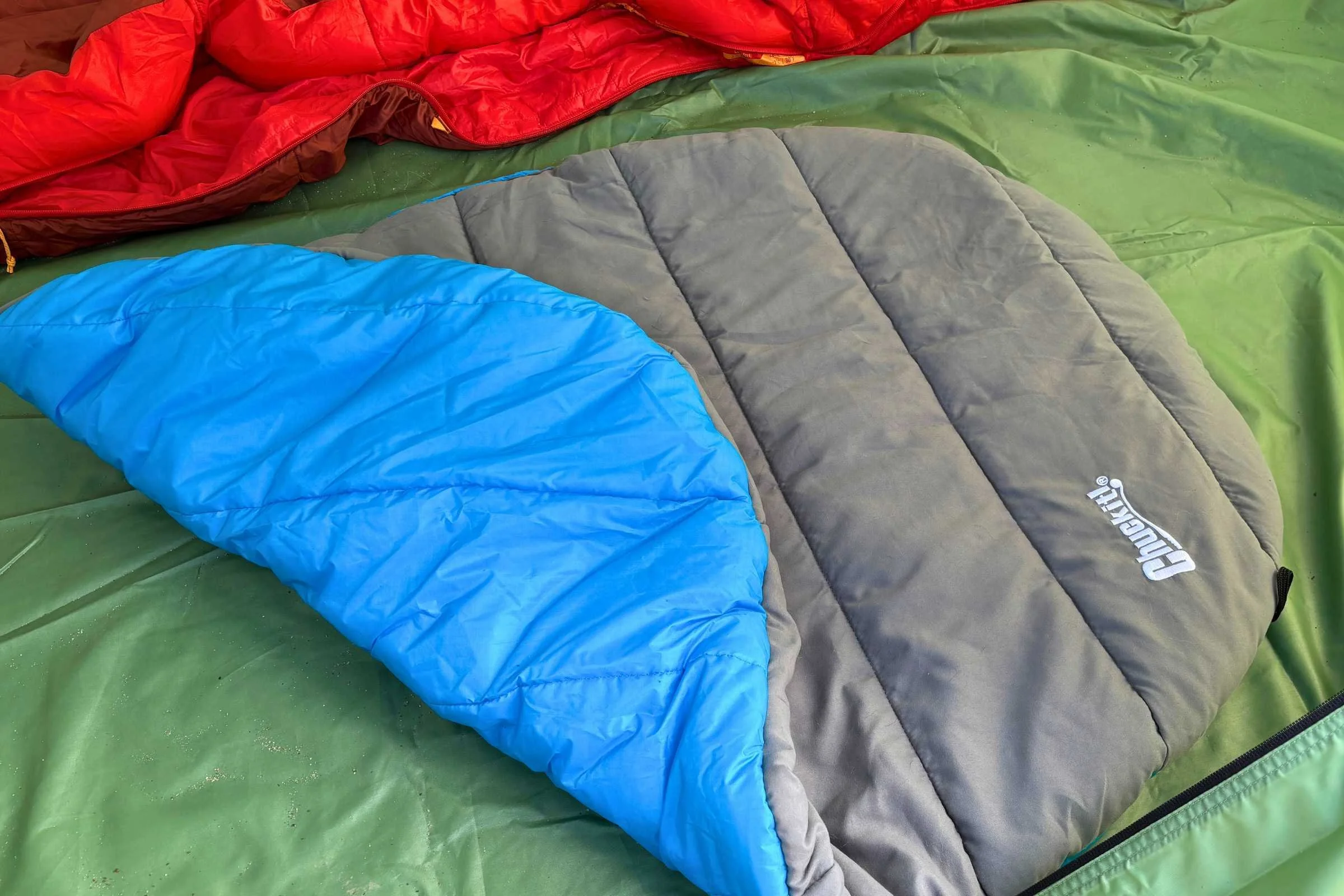 The blue side of the ChuckIt! bed was a bit slippery inside a tent.