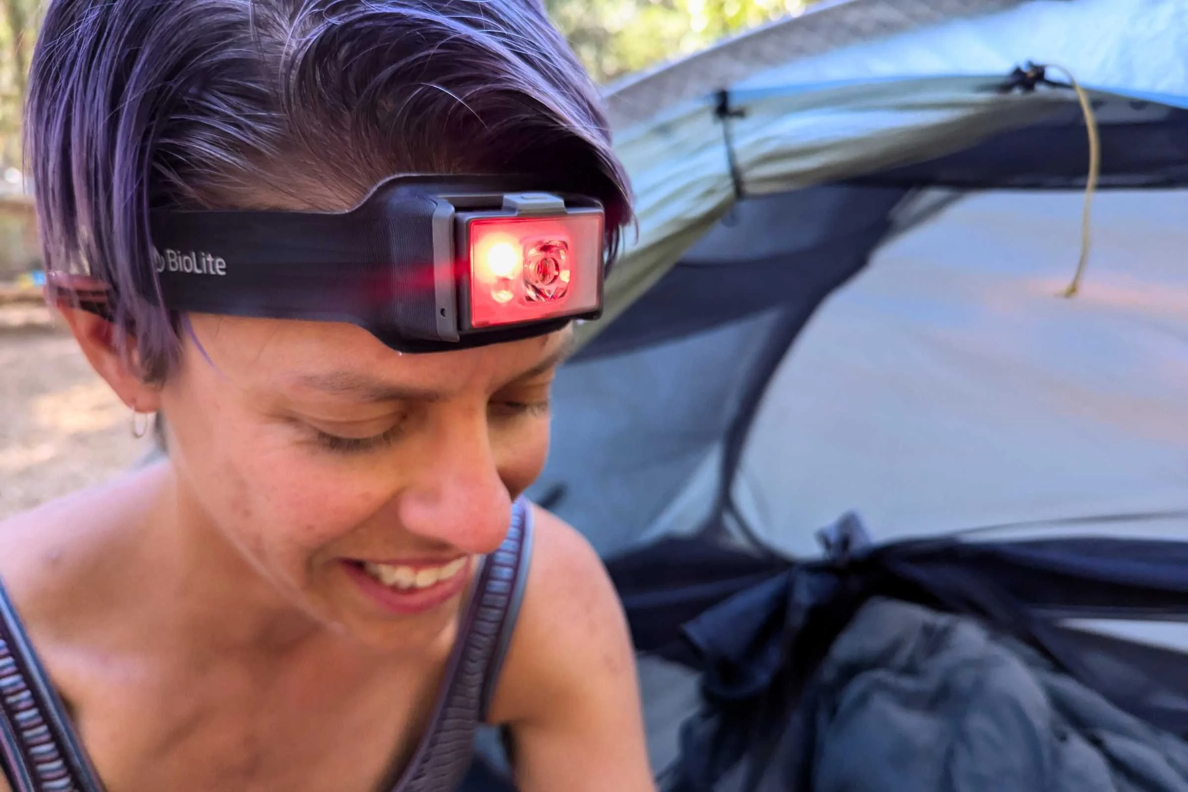 Camper using the red light on the BioLite 800 Pro