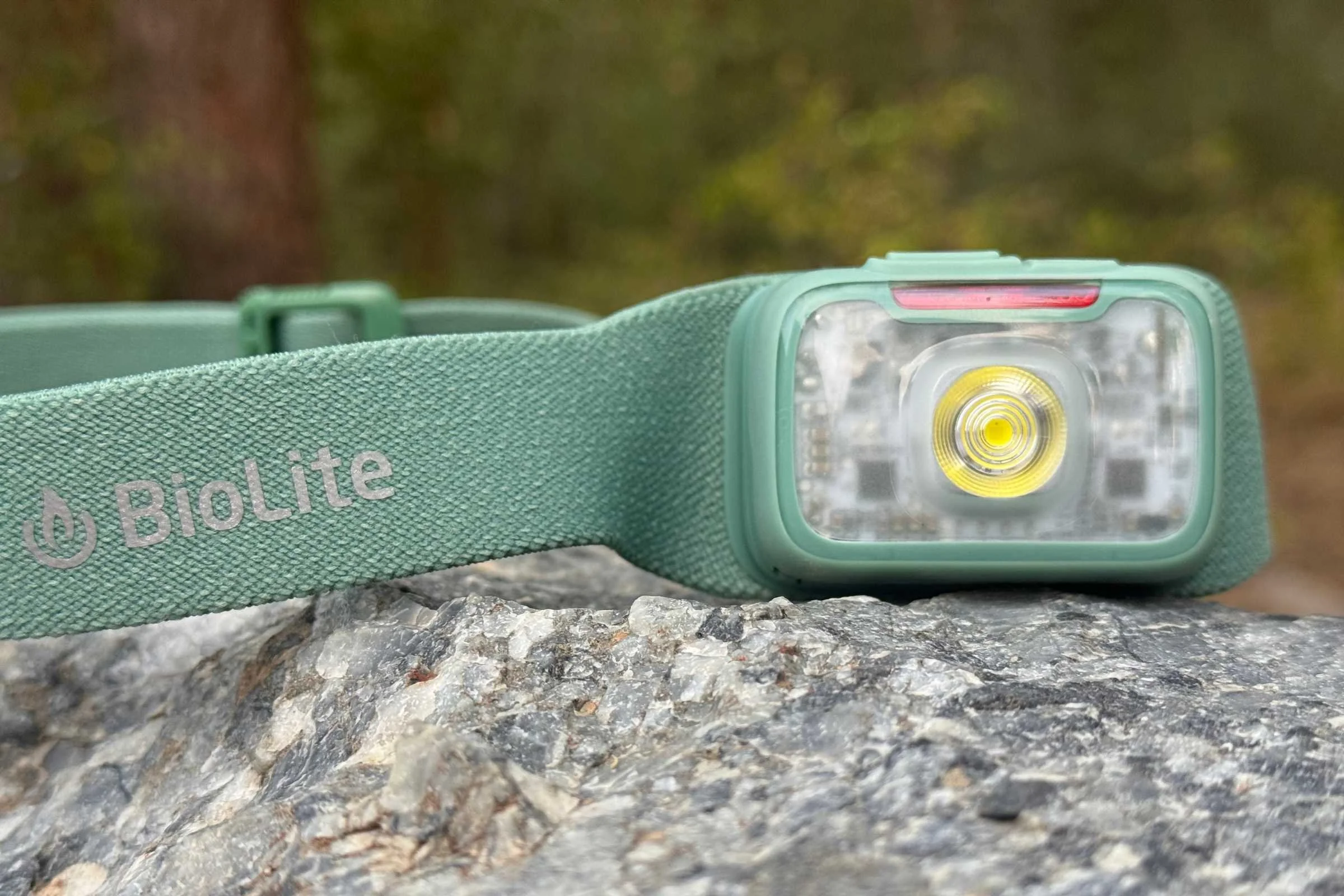 Closeup of the BioLite Range 400 headlamp on a rock in a forest