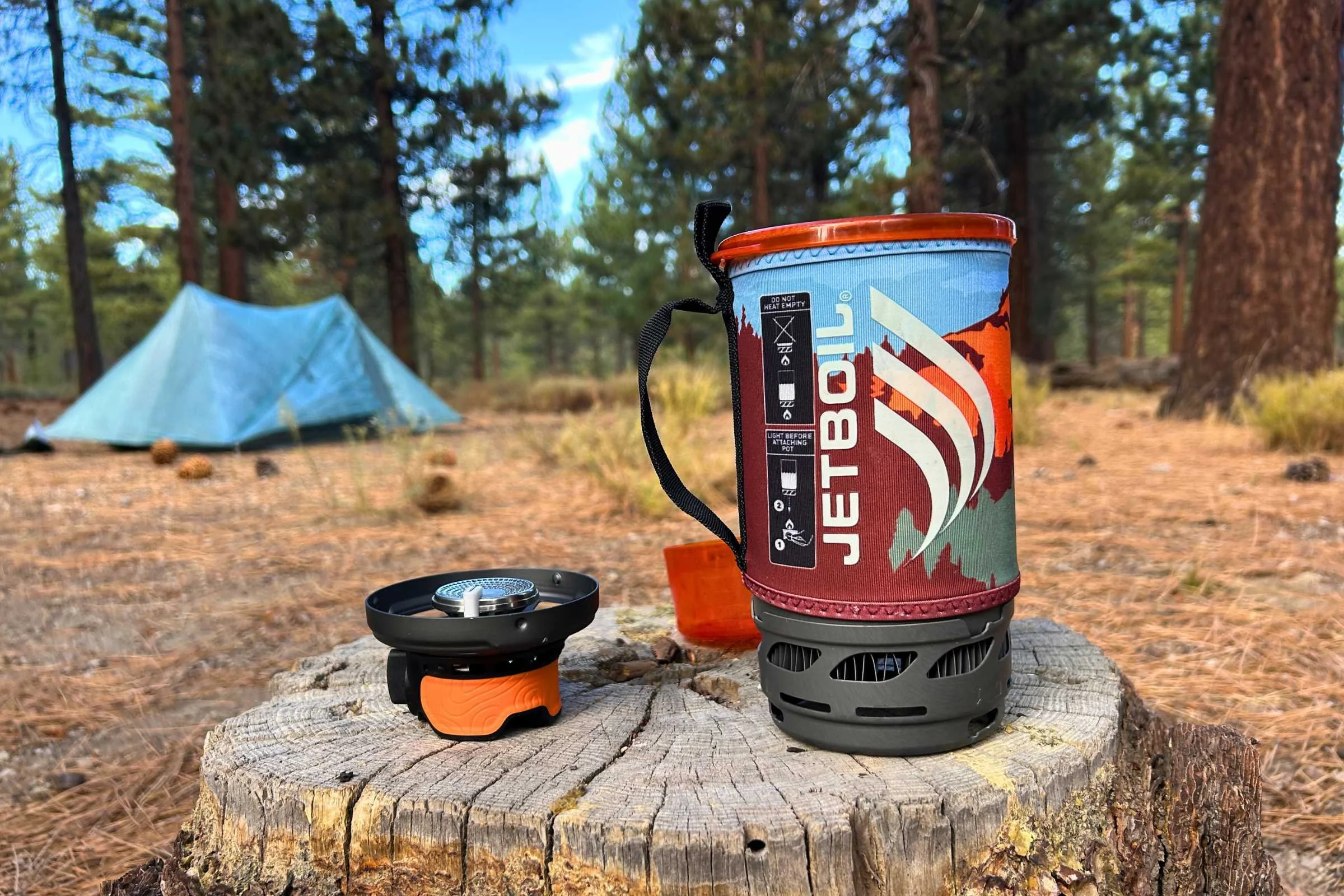 The jetboil flash 1.0 on a log at a campsite