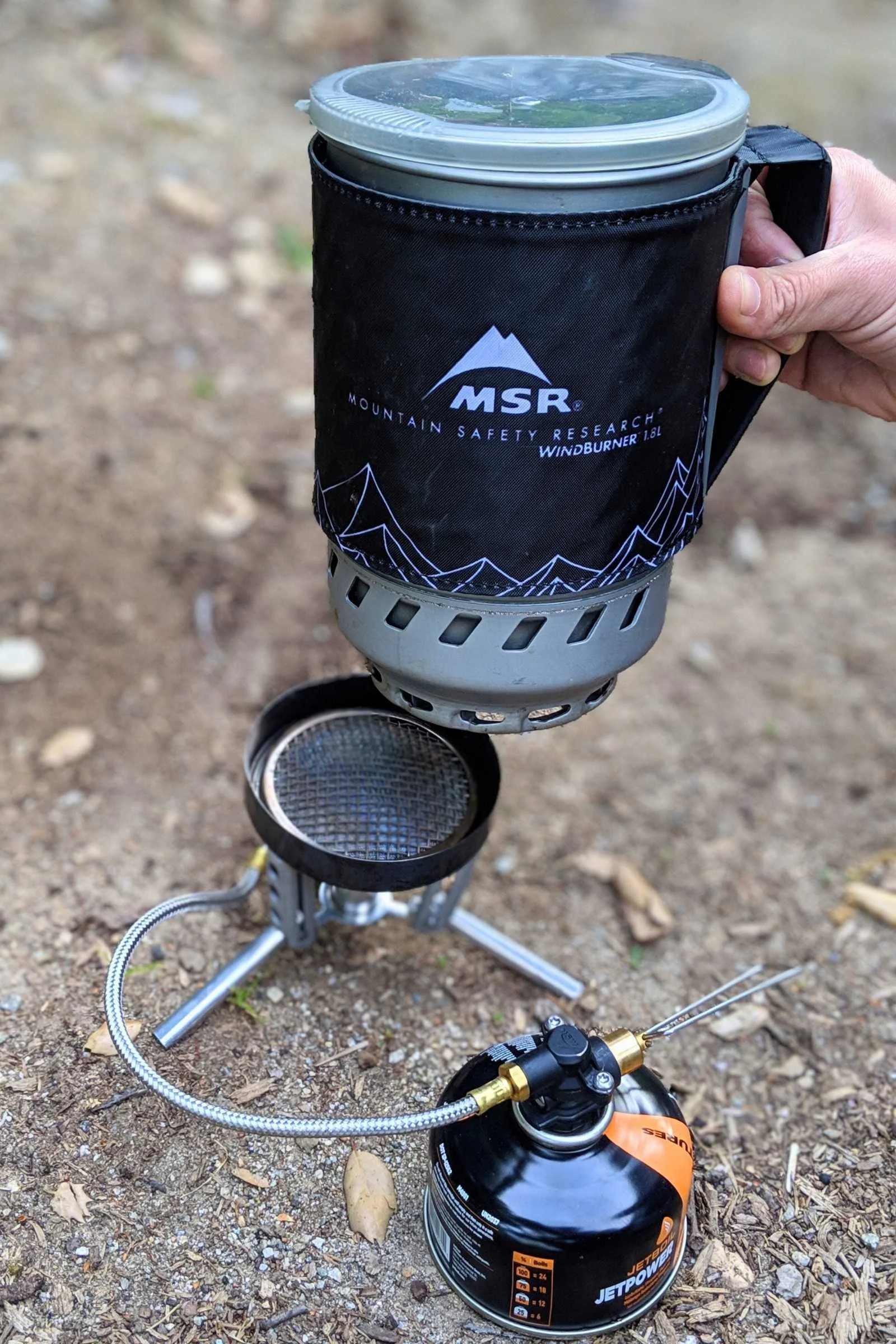   testing the MSR WindBurner on the ground and on picnic tables at campsites  