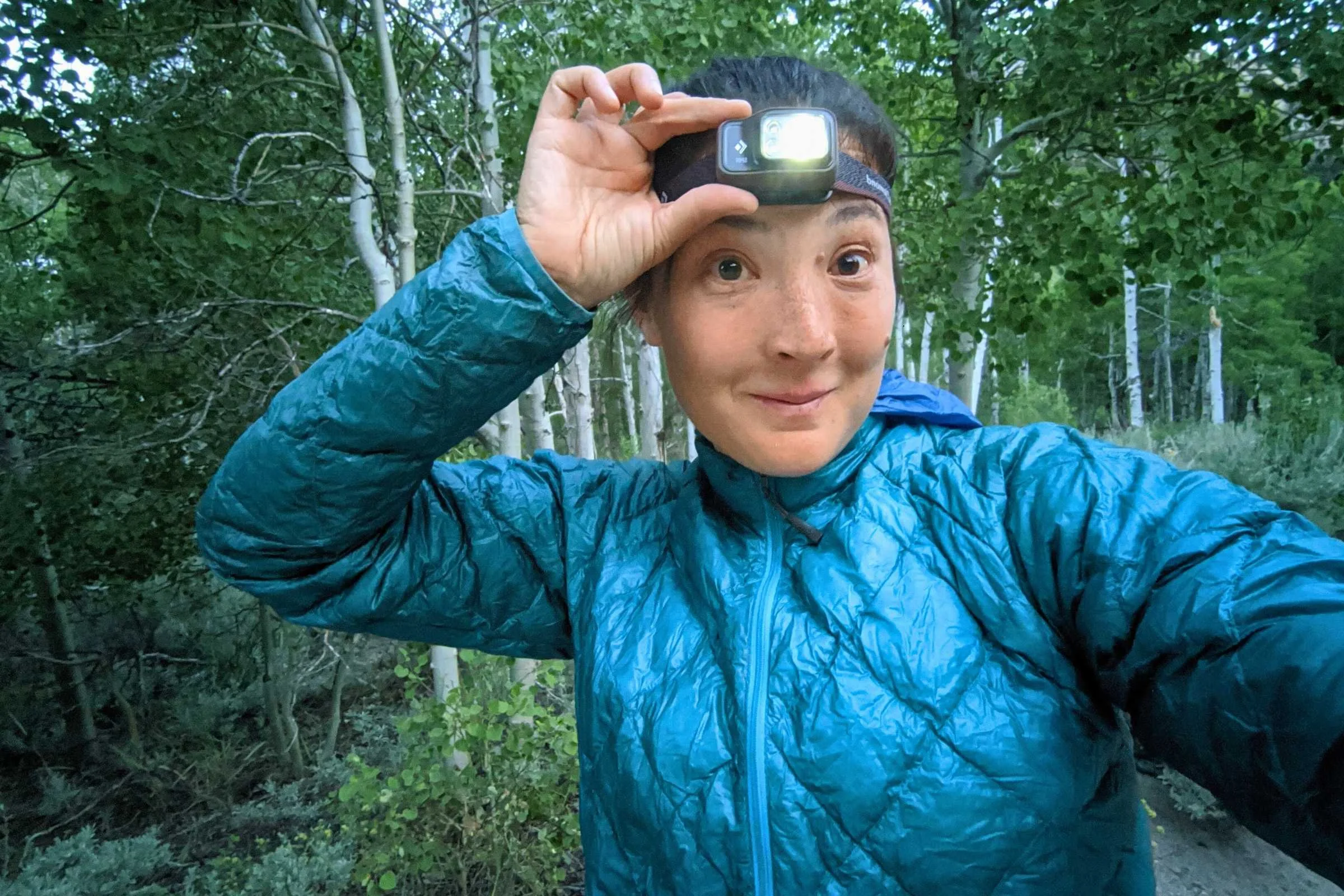 Author Liz wearing the Black Diamond Spot 400 and demonstrating how easy it is to turn on.