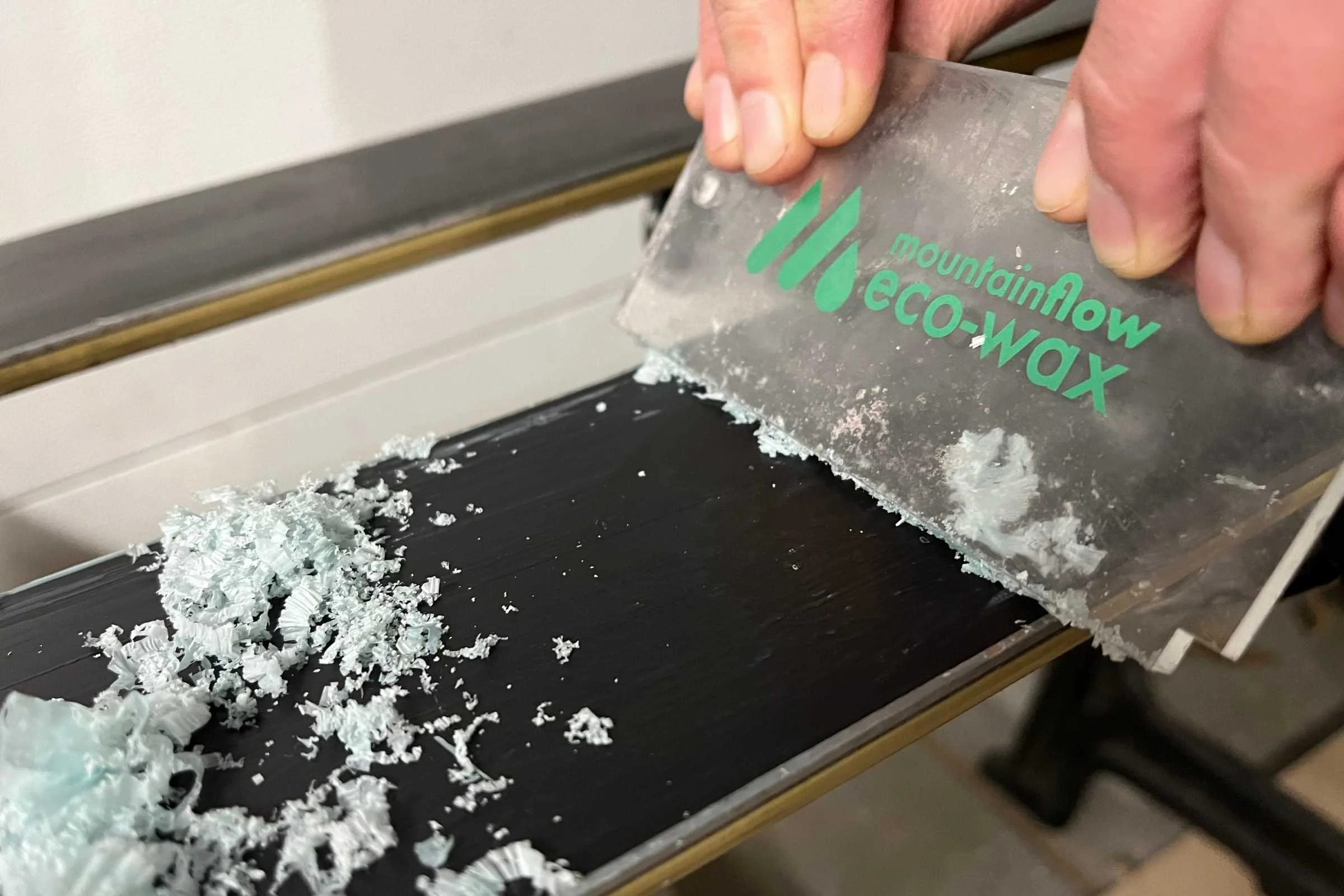Scraping wax with the plastic scraper included with the Mountain Flow kit. Mountain Flow wax uses fewer harsh chemicals that traditional waxes, which is better for the environment because small amounts of wax do come off of ski and board bases when