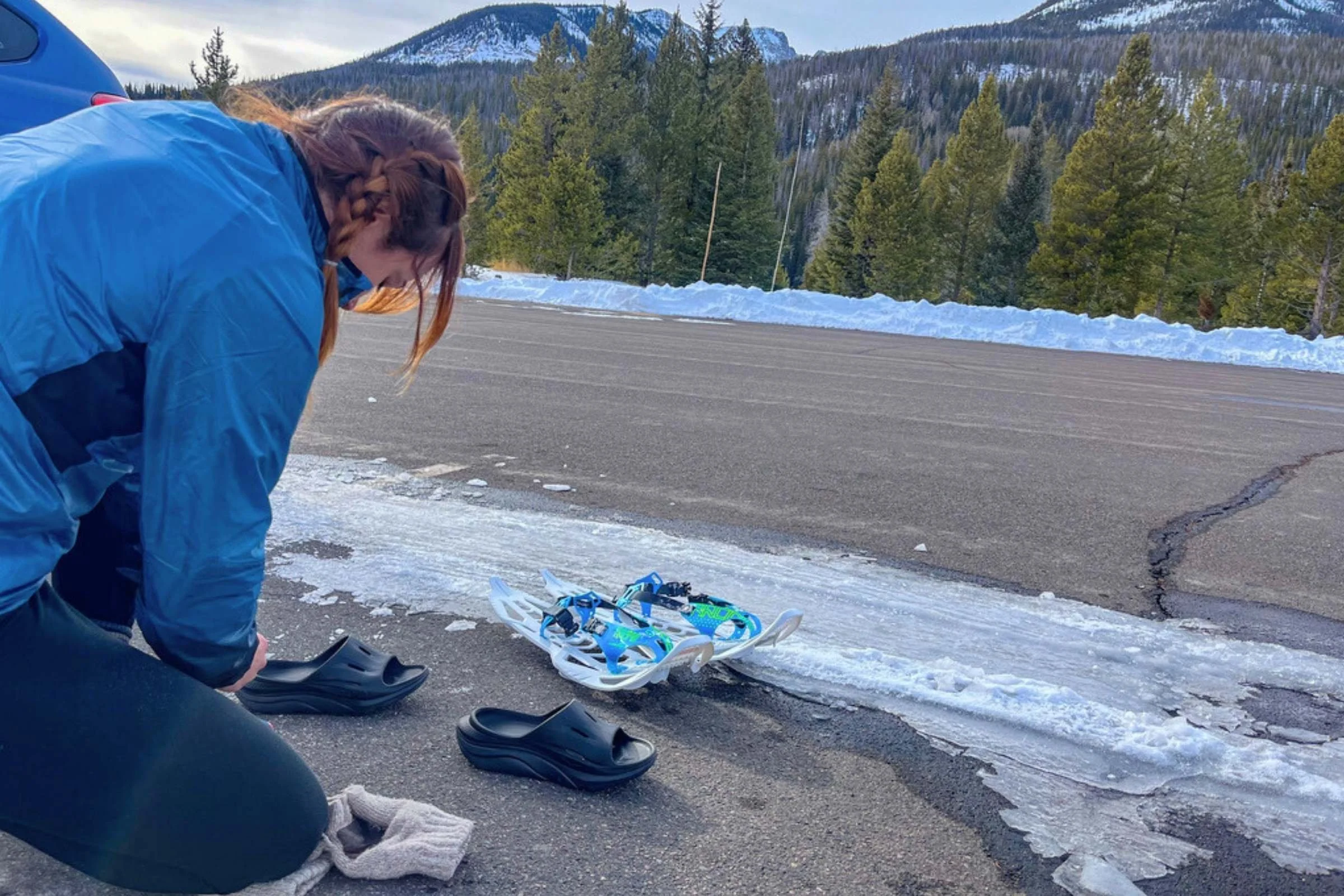 Tester Becca Downs changing into recovery shoes after a snowshoe run in the Symbioz Racing Snowshoes in Rocky Mountain National Park.